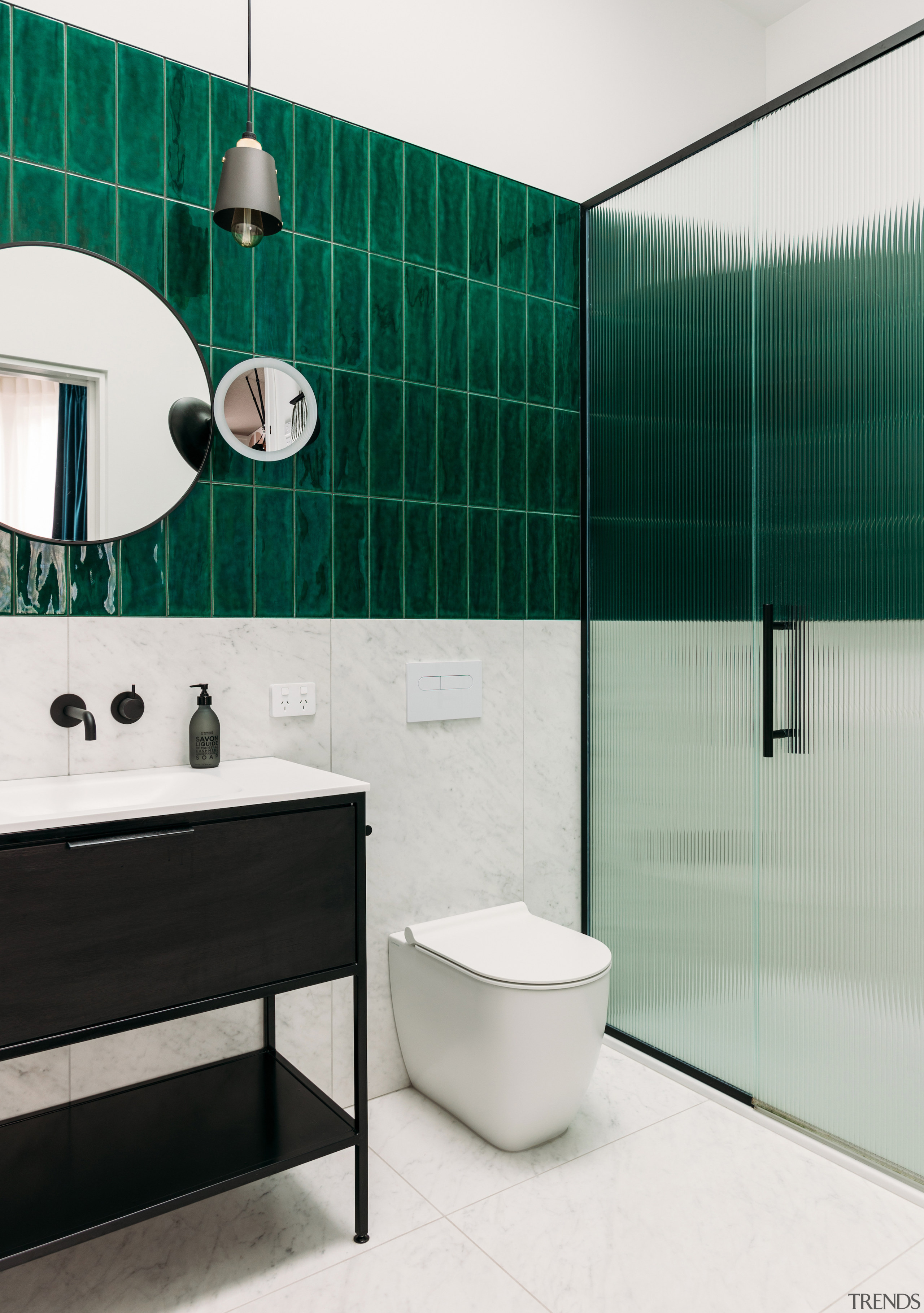 The master ensuite echoes the main bathroom's finishes. 