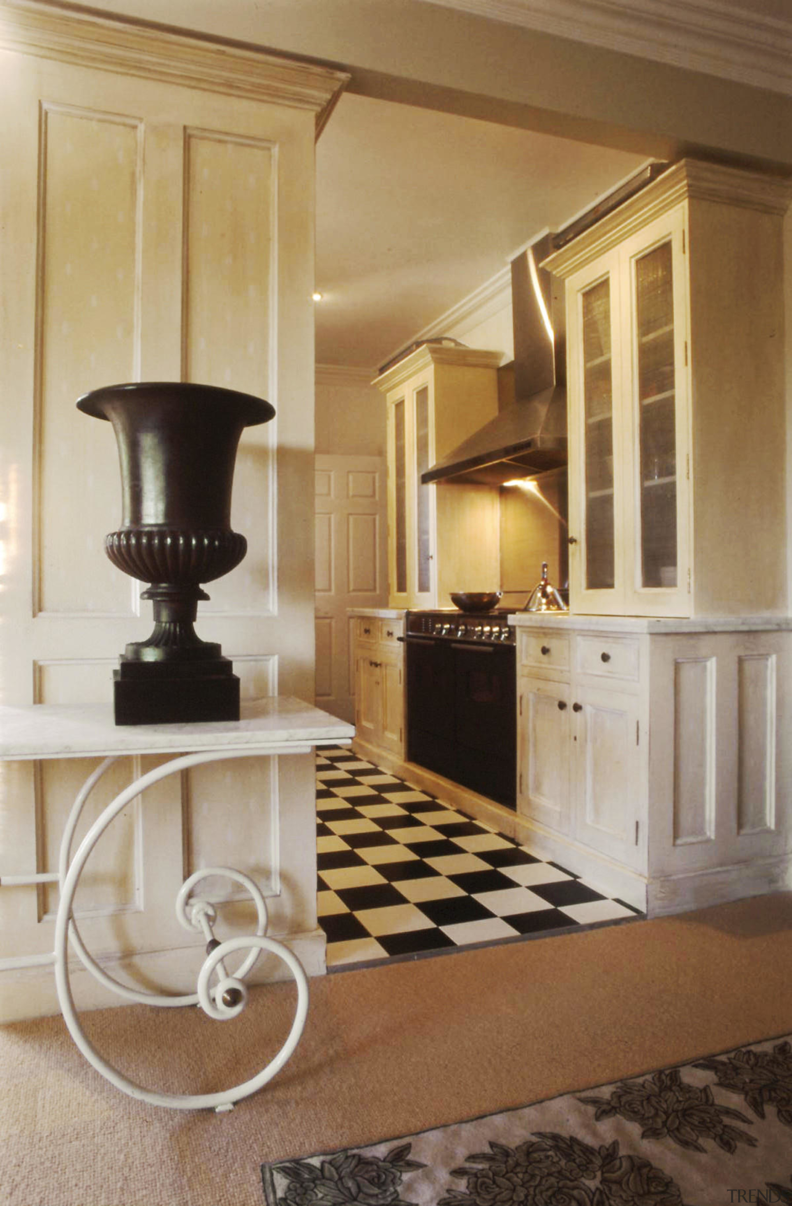This kitchen sees classic wood cabinetry juxtaposed with floor, flooring, furniture, hardwood, home, interior design, living room, molding, room, table, wood flooring, brown, orange