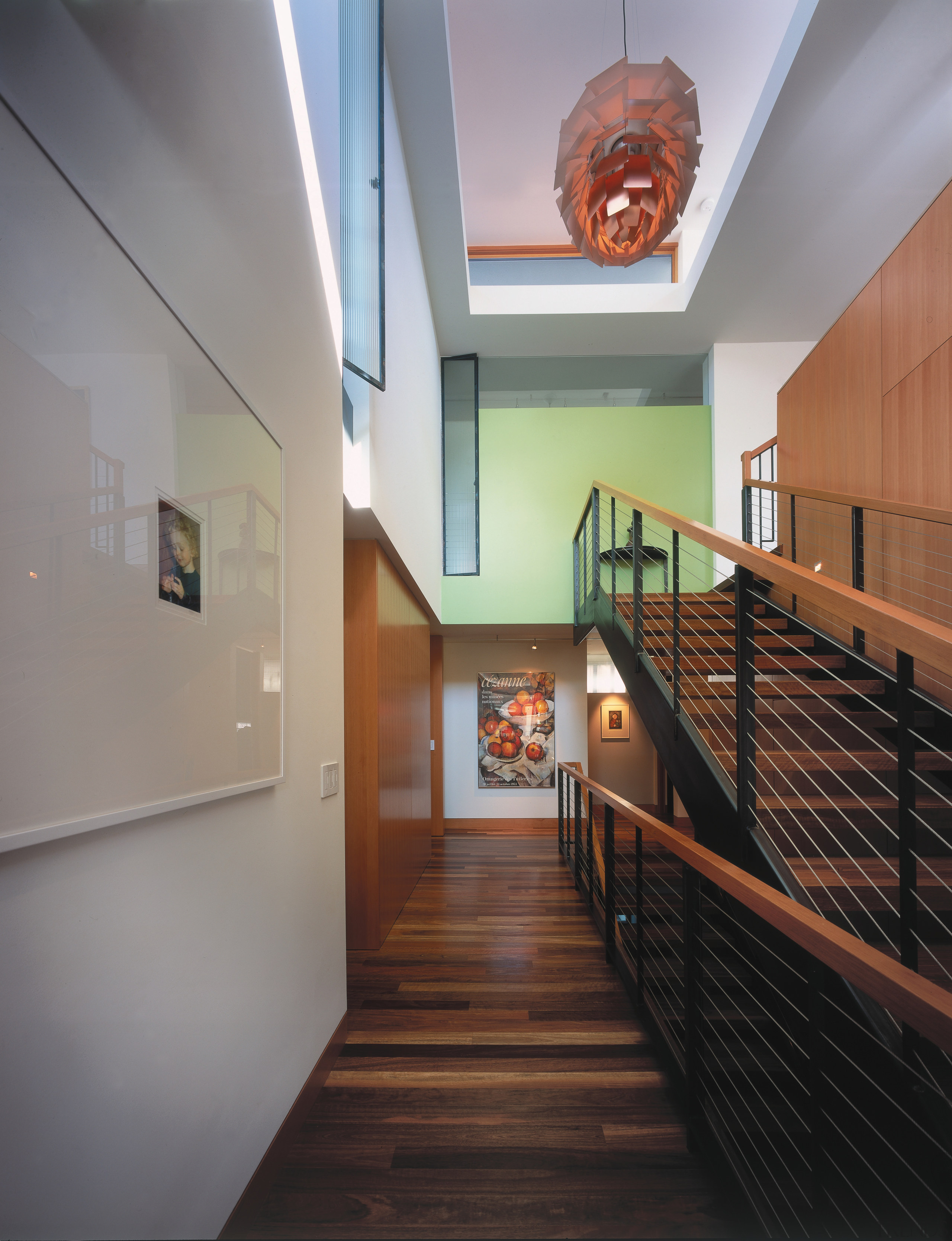 view of the hallway and staircase featuring orange apartment, architecture, ceiling, daylighting, estate, floor, flooring, handrail, hardwood, home, house, interior design, property, real estate, stairs, wood, gray