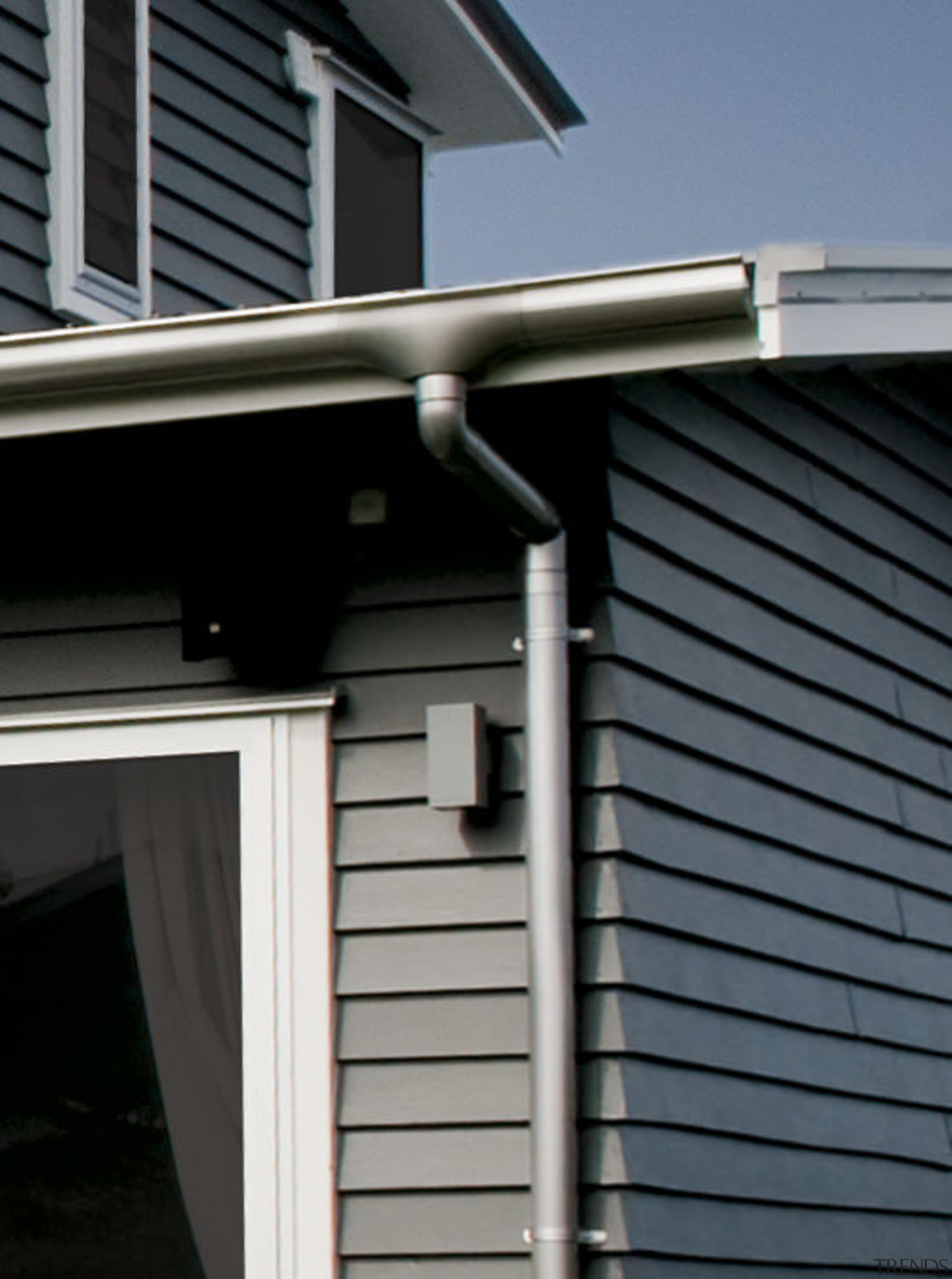 Close up of downpipe. - Close up of daylighting, facade, house, roof, siding, window, black, gray