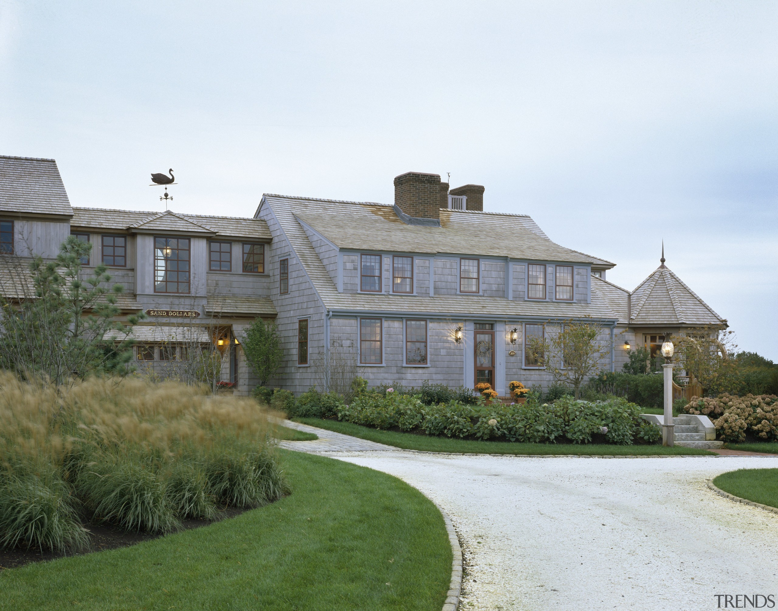 Exterior view of a large cottage with cedar cottage, estate, facade, farmhouse, home, house, landscaping, mansion, property, real estate, residential area, roof, window, white