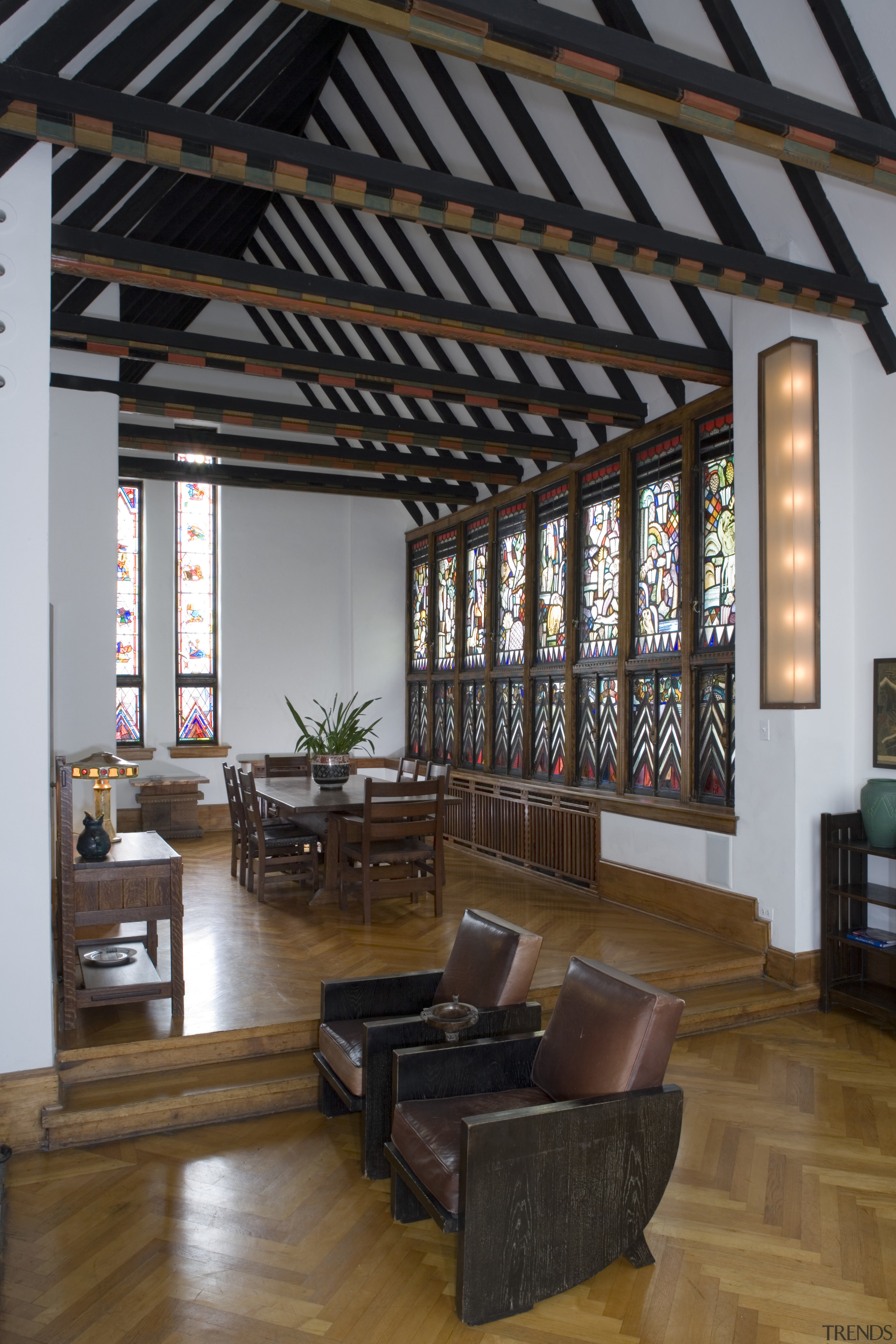 View of the main lounge featuring rafters, wooden ceiling, daylighting, interior design, living room, window, black, gray, brown