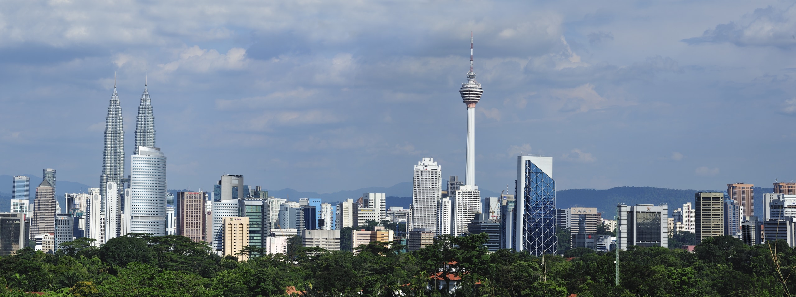 The new Menara Bumiputra Commerce tower is appropriate building, city, cityscape, cloud, daytime, downtown, horizon, landmark, metropolis, metropolitan area, sky, skyline, skyscraper, tower, tower block, tree, urban area, teal