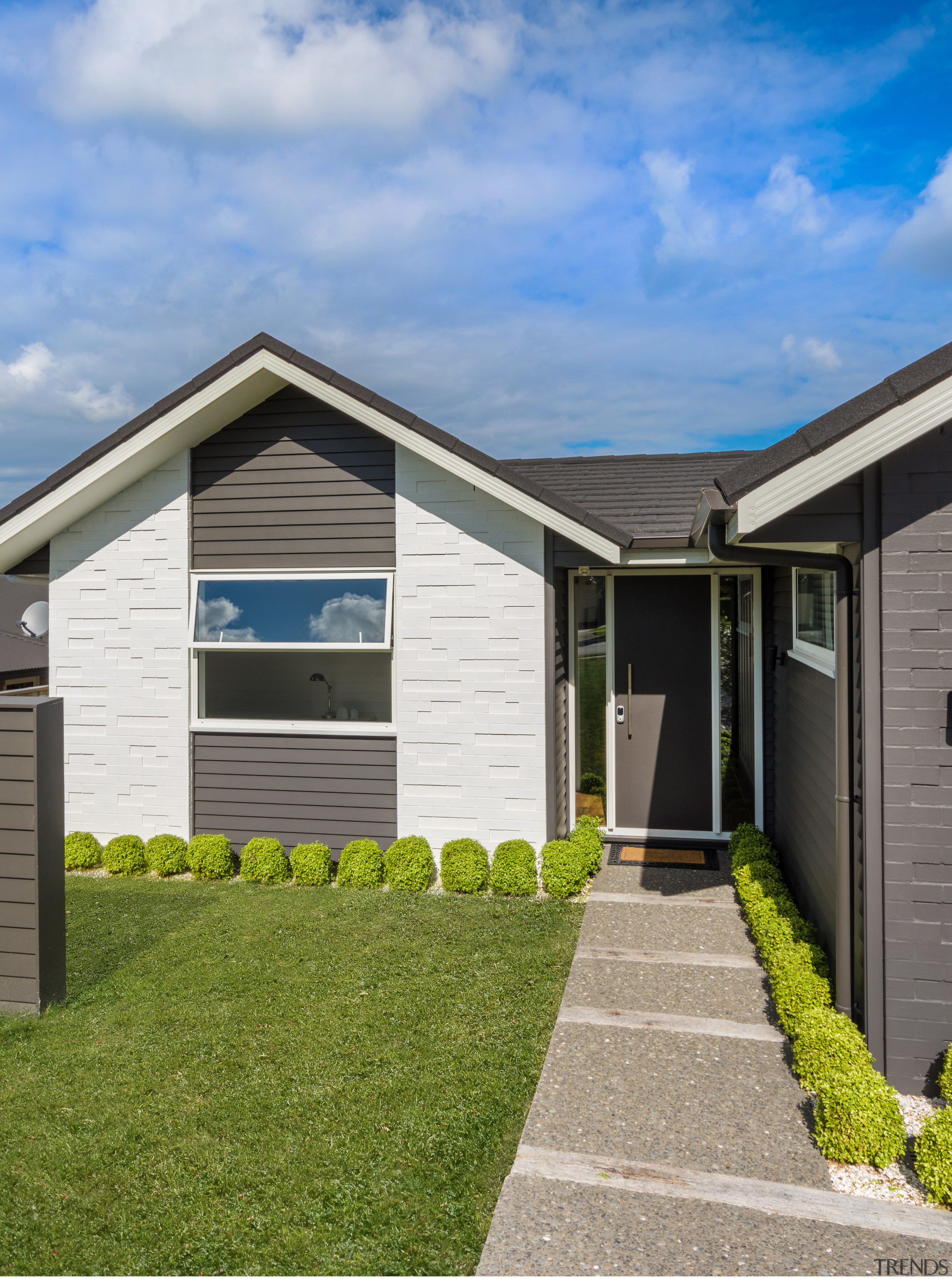 Clad in painted brick and weatherboard, this Landmark cottage, elevation, estate, facade, grass, home, house, property, real estate, residential area, shed, siding, sky, window, yard, teal