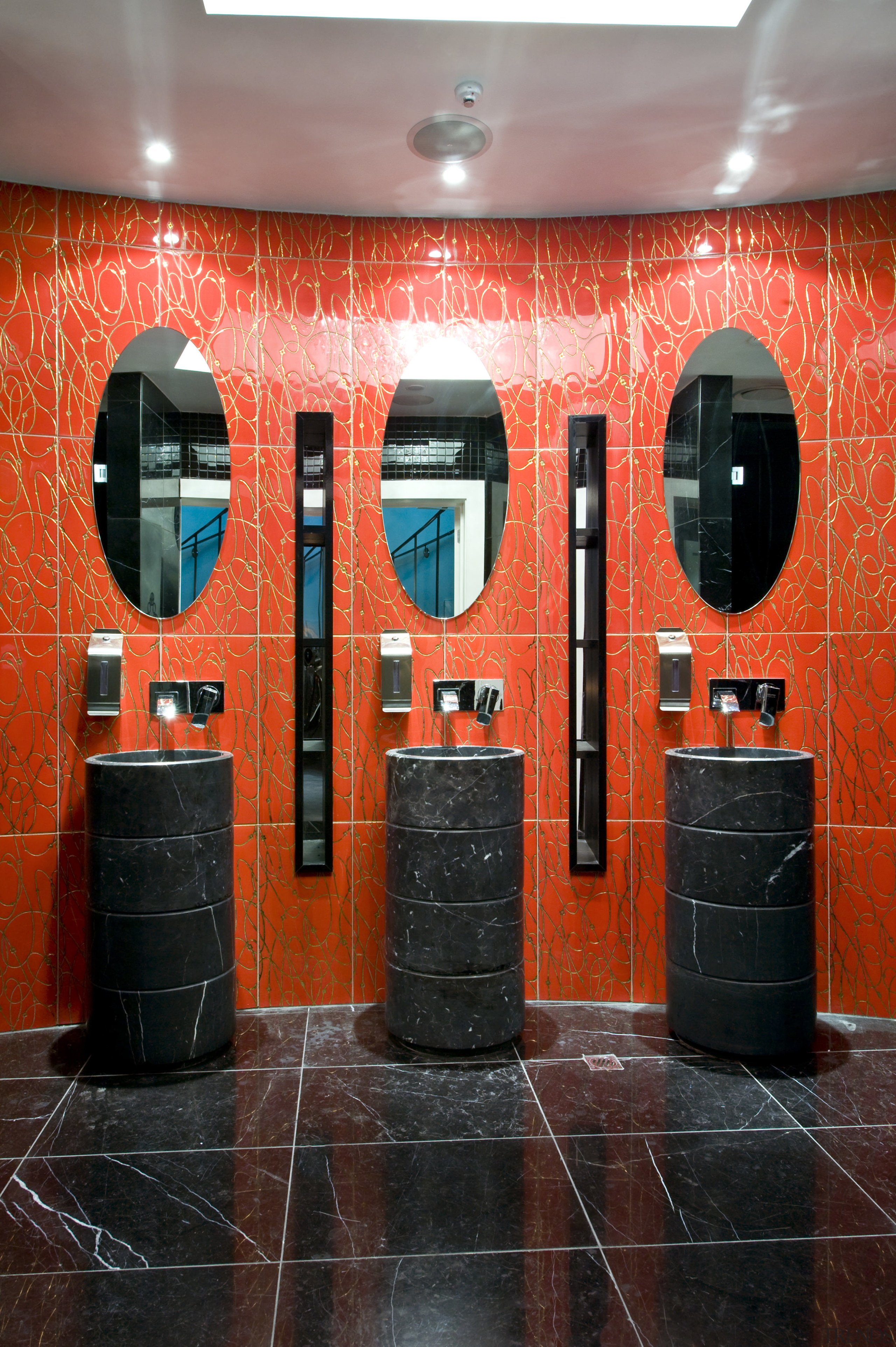 A decorative motif features throughout the interior. The interior design, orange, public toilet, red, room, wall, red