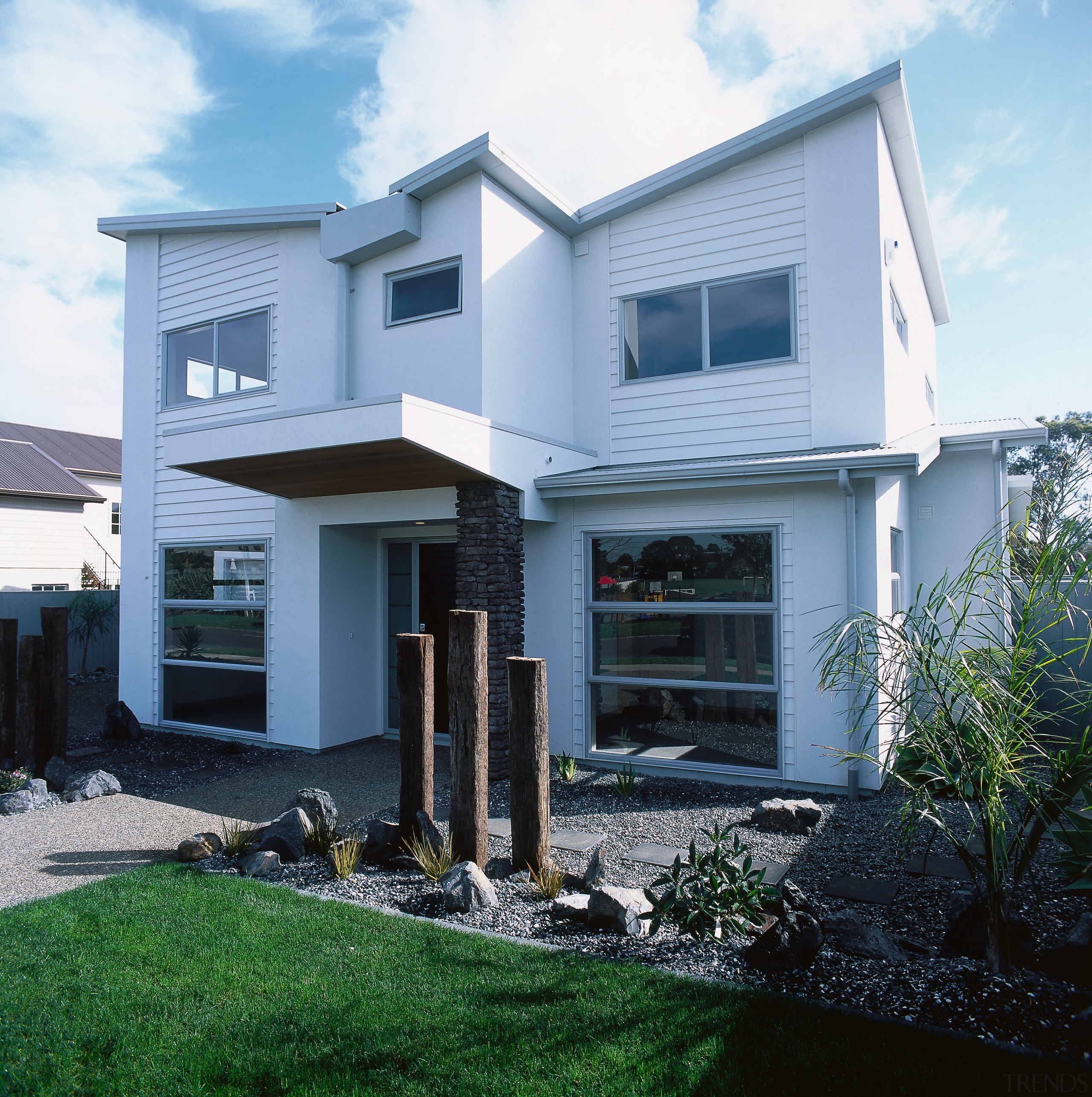 view of this contemporary jalcon show home featuring architecture, building, elevation, facade, home, house, property, real estate, residential area, siding, window, white, black