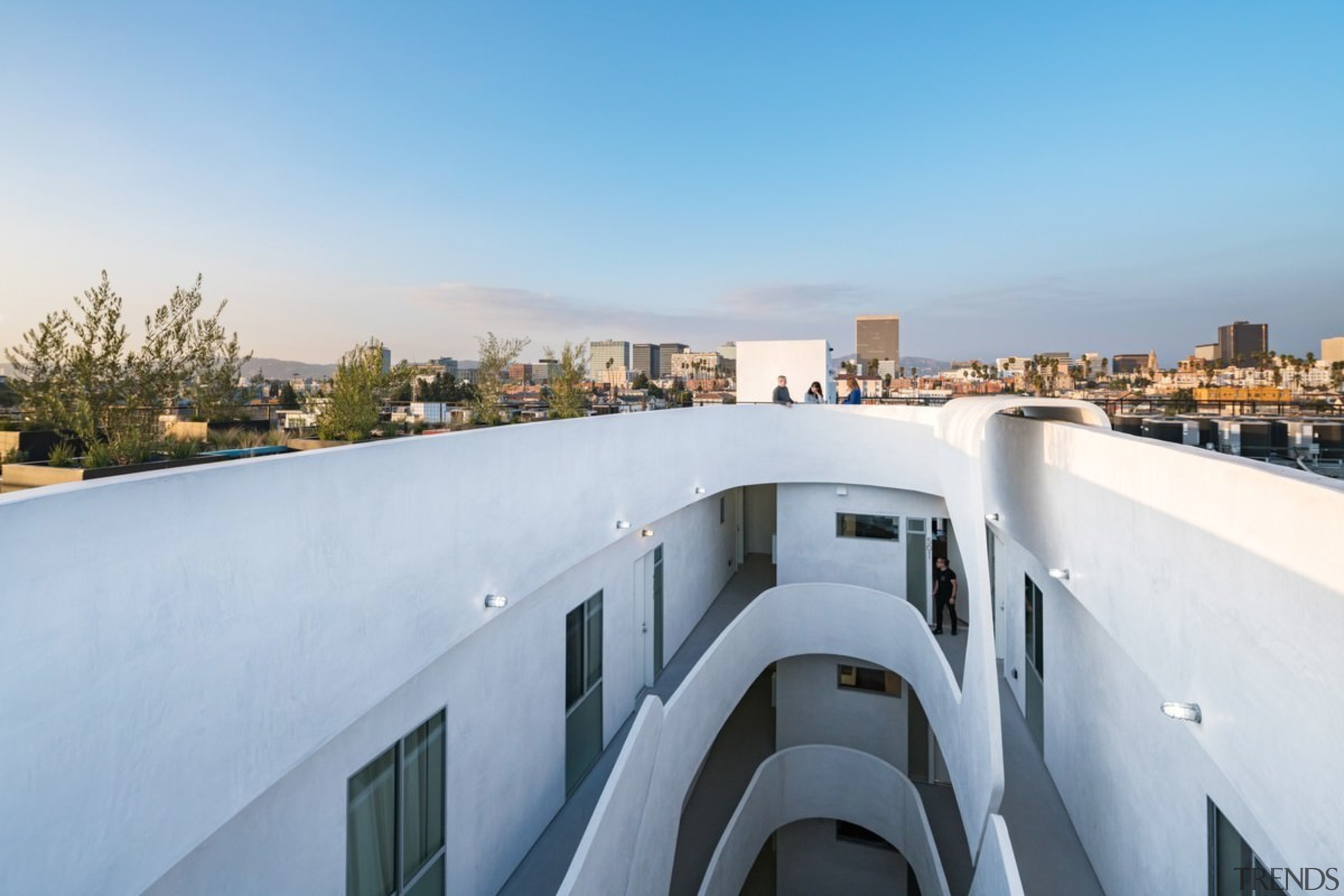 The 'O' shaped building means there's room for apartment, architecture, building, property, real estate, roof, sky, gray, teal