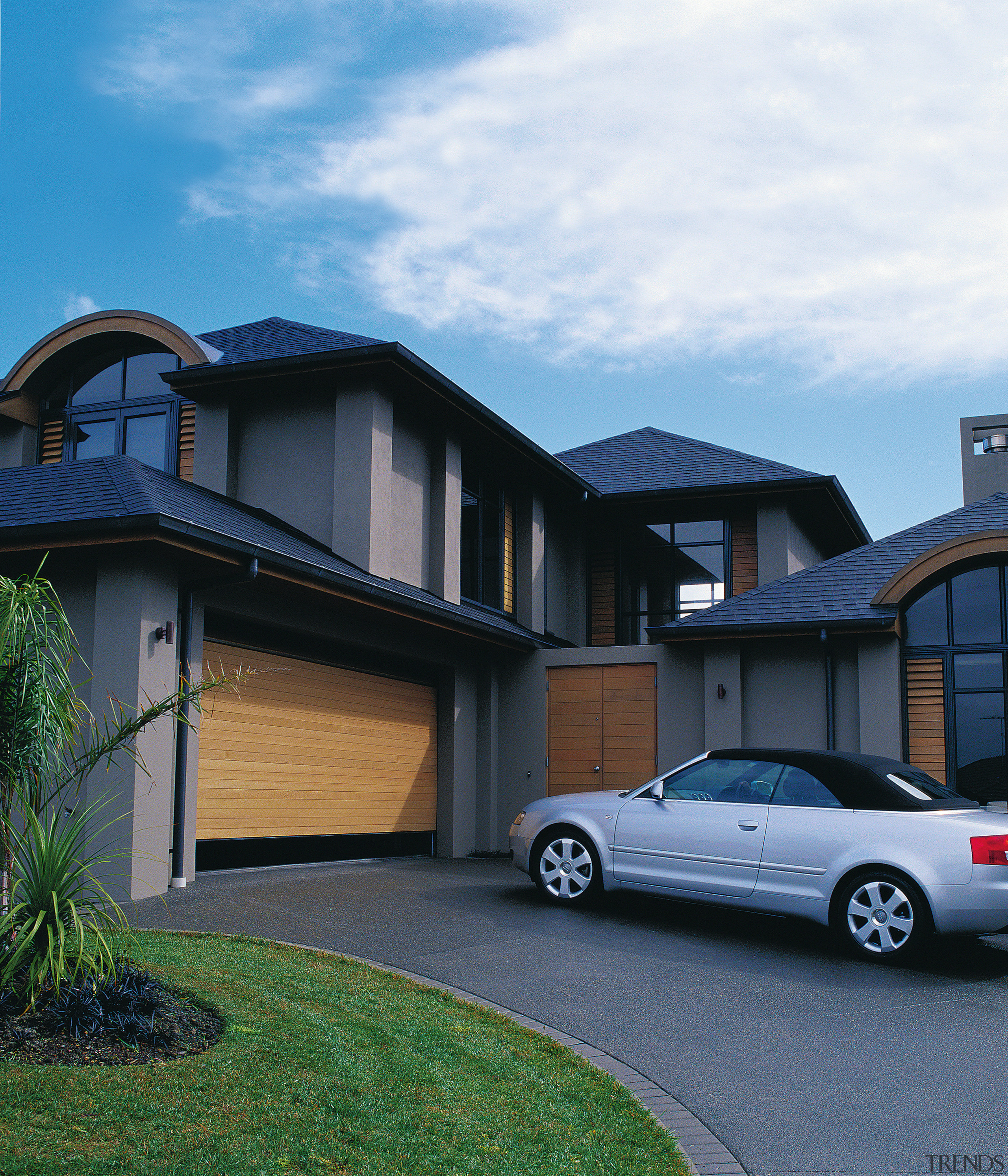 A view of a timber garage door by architecture, automotive exterior, building, car, elevation, estate, facade, family car, home, house, luxury vehicle, mid size car, motor vehicle, property, real estate, residential area, siding, suburb, window