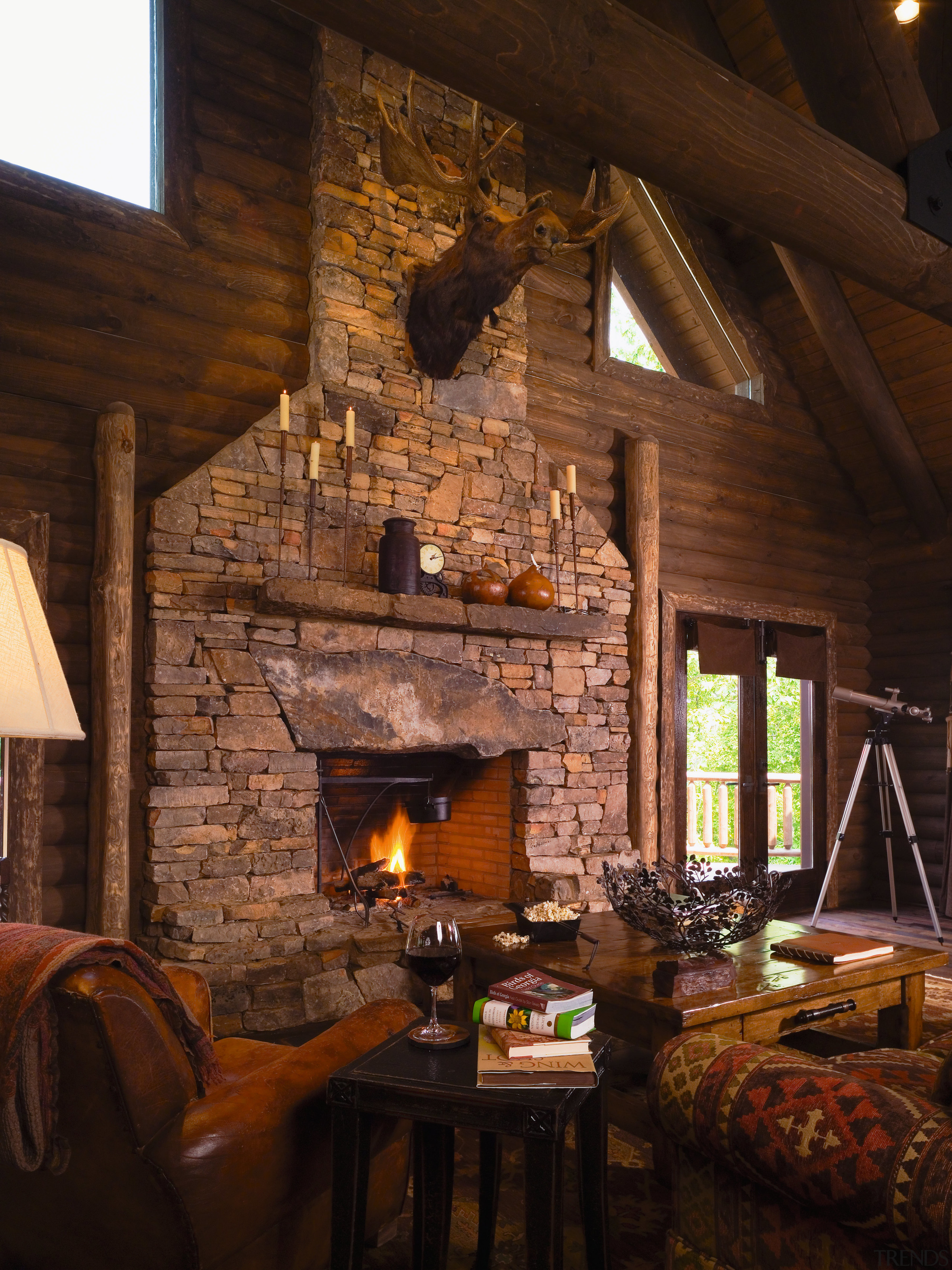 view of the lounge/entrance in this vacation home beam, fireplace, hearth, home, interior design, lighting, living room, log cabin, room, wood, black, brown