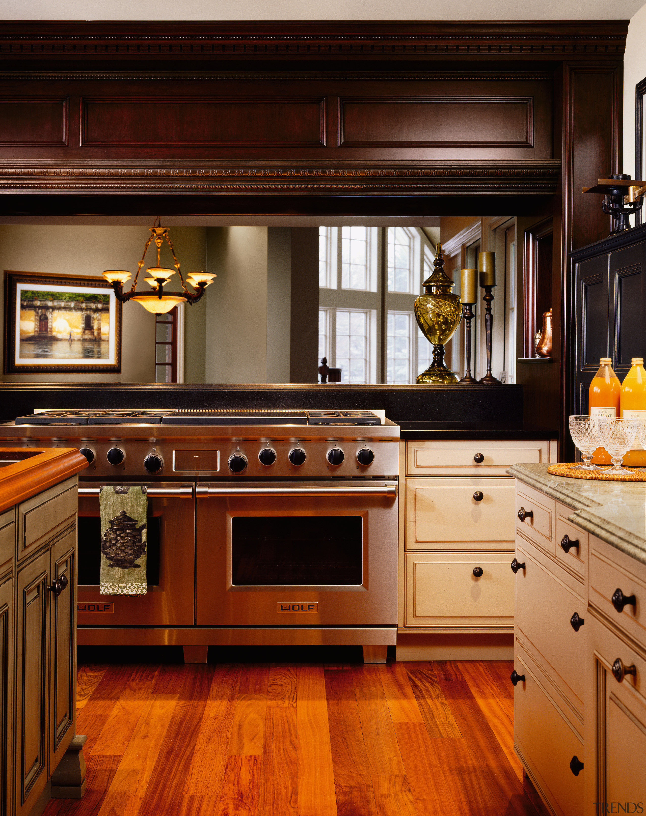 A view of a kitchen by NuHaus Custom cabinetry, countertop, cuisine classique, floor, flooring, hardwood, home appliance, interior design, kitchen, kitchen appliance, kitchen stove, room, under cabinet lighting, wood flooring, brown