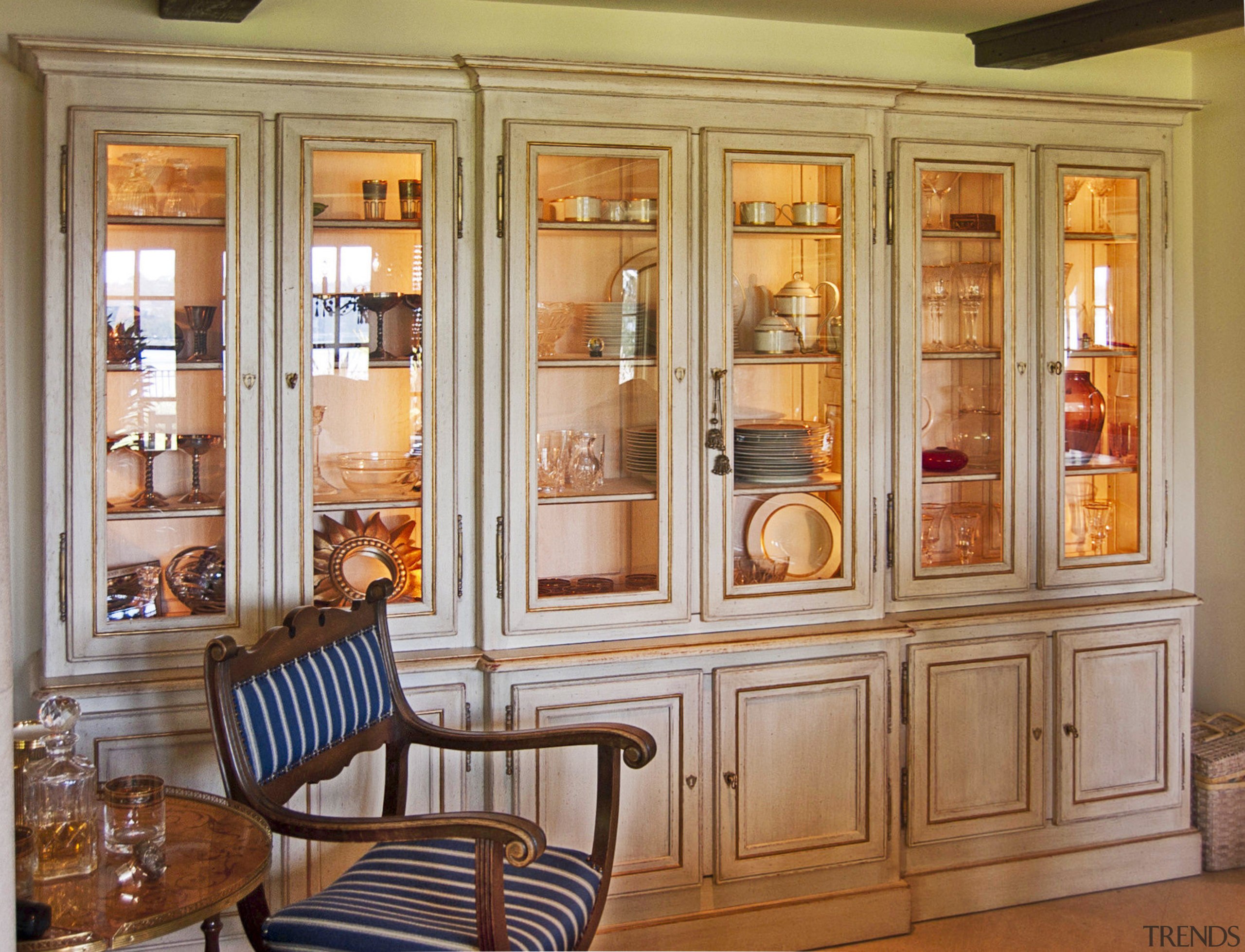 Cabinets in this traditional Provencal-style kitchen has a bookcase, cabinetry, cupboard, dining room, display case, door, furniture, interior design, living room, room, shelf, shelving, window, orange, brown