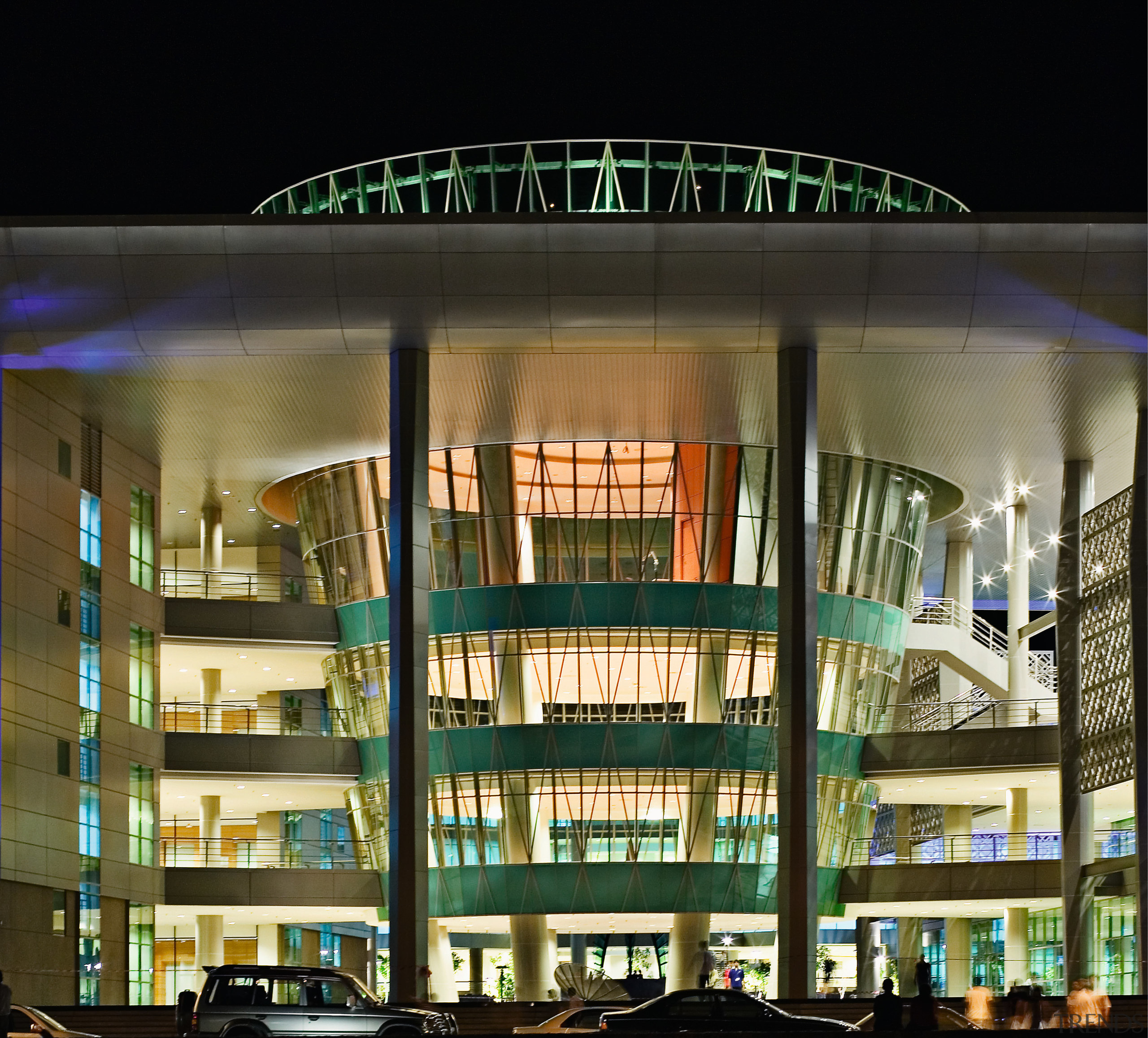 view of the exterior and glass facade of architecture, building, commercial building, condominium, mixed use, night, structure, brown, black