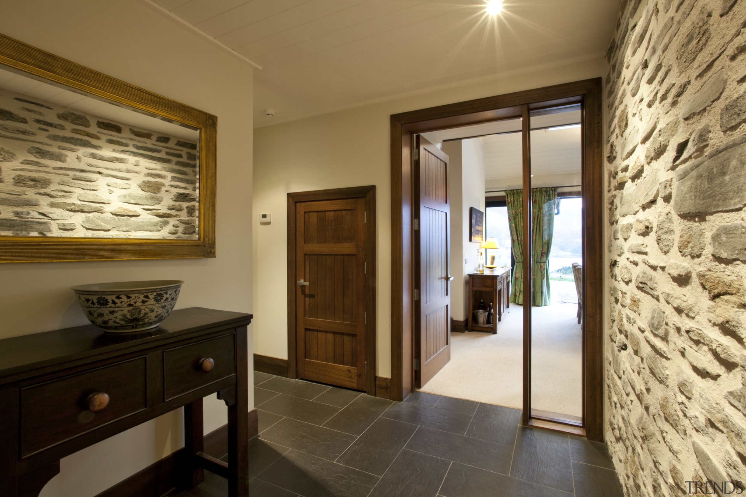 View of entrance with grey flooring, stone wall ceiling, door, estate, interior design, property, real estate, room, suite, brown, orange