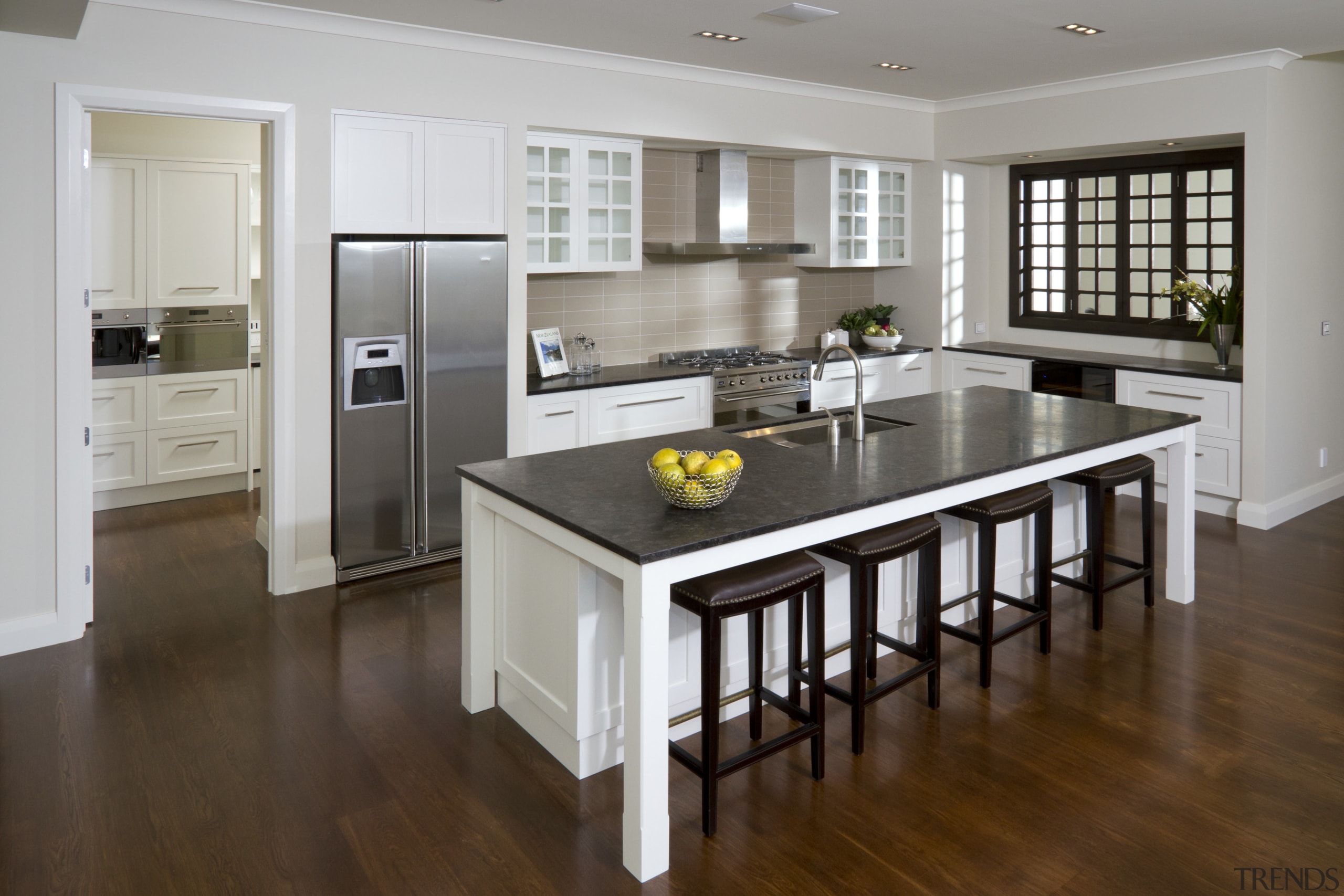 View of kitchen with wooden flooring, dark benchtops cabinetry, countertop, cuisine classique, floor, flooring, hardwood, interior design, kitchen, laminate flooring, real estate, room, wood flooring, gray, brown