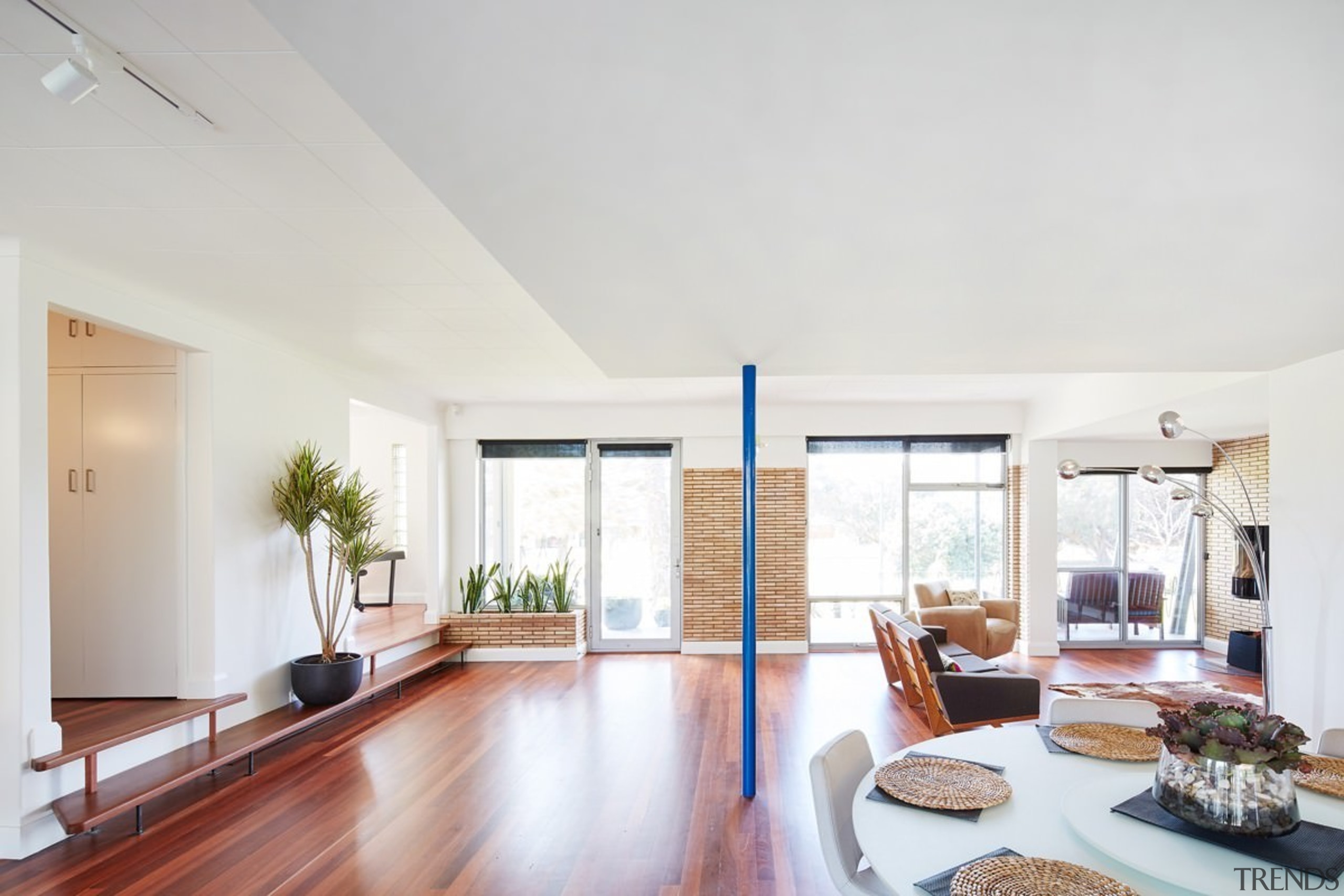 The living area is slightly lower than the apartment, ceiling, daylighting, estate, floor, house, interior design, living room, property, real estate, window, white