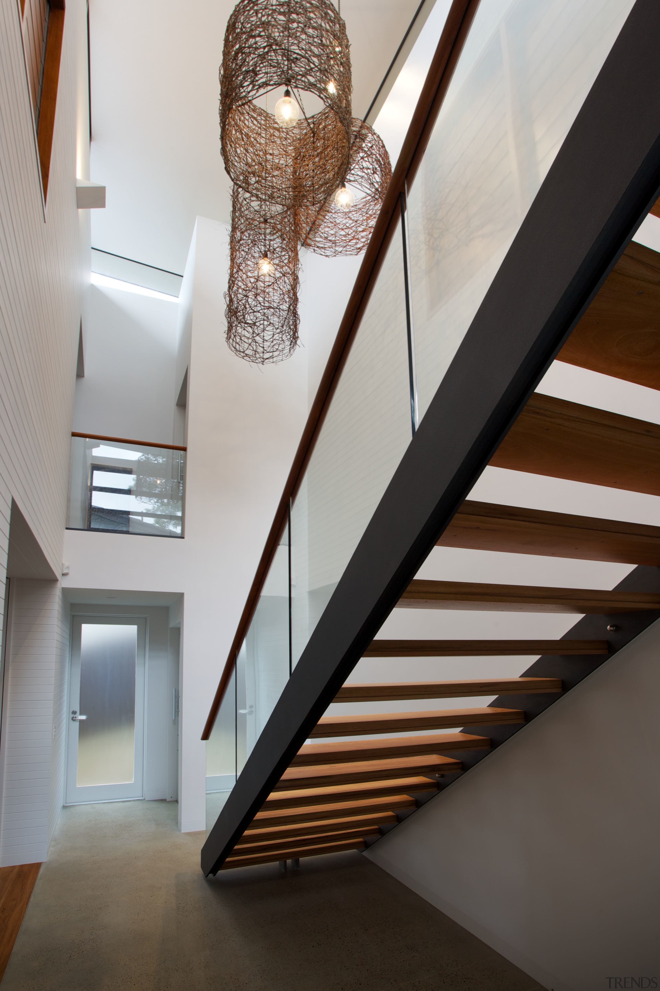 A open-tread, steel staircase is a sculptural feature architecture, ceiling, daylighting, handrail, house, interior design, light fixture, lighting, stairs, gray