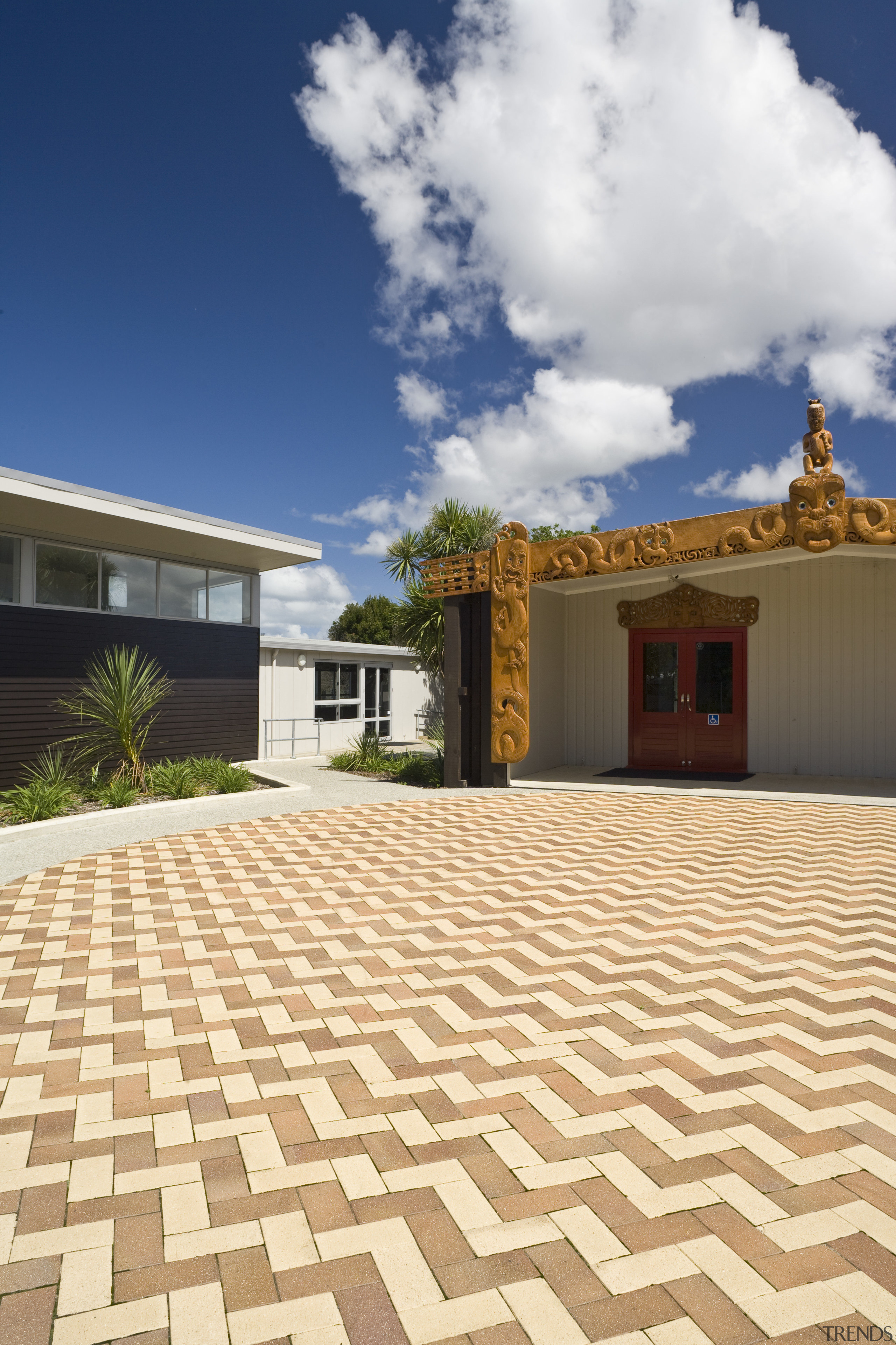Image of Te Whanau o tupuranga school which estate, facade, floor, flooring, home, house, property, real estate, roof, sky, villa, orange