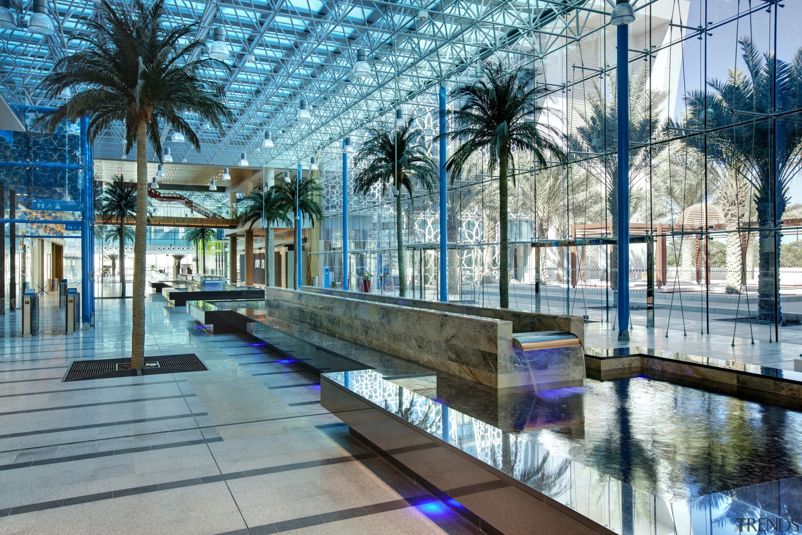 View of interior with palms and turquoise lighting. arecales, condominium, leisure, leisure centre, palm tree, real estate, reflection, resort, swimming pool, water, teal