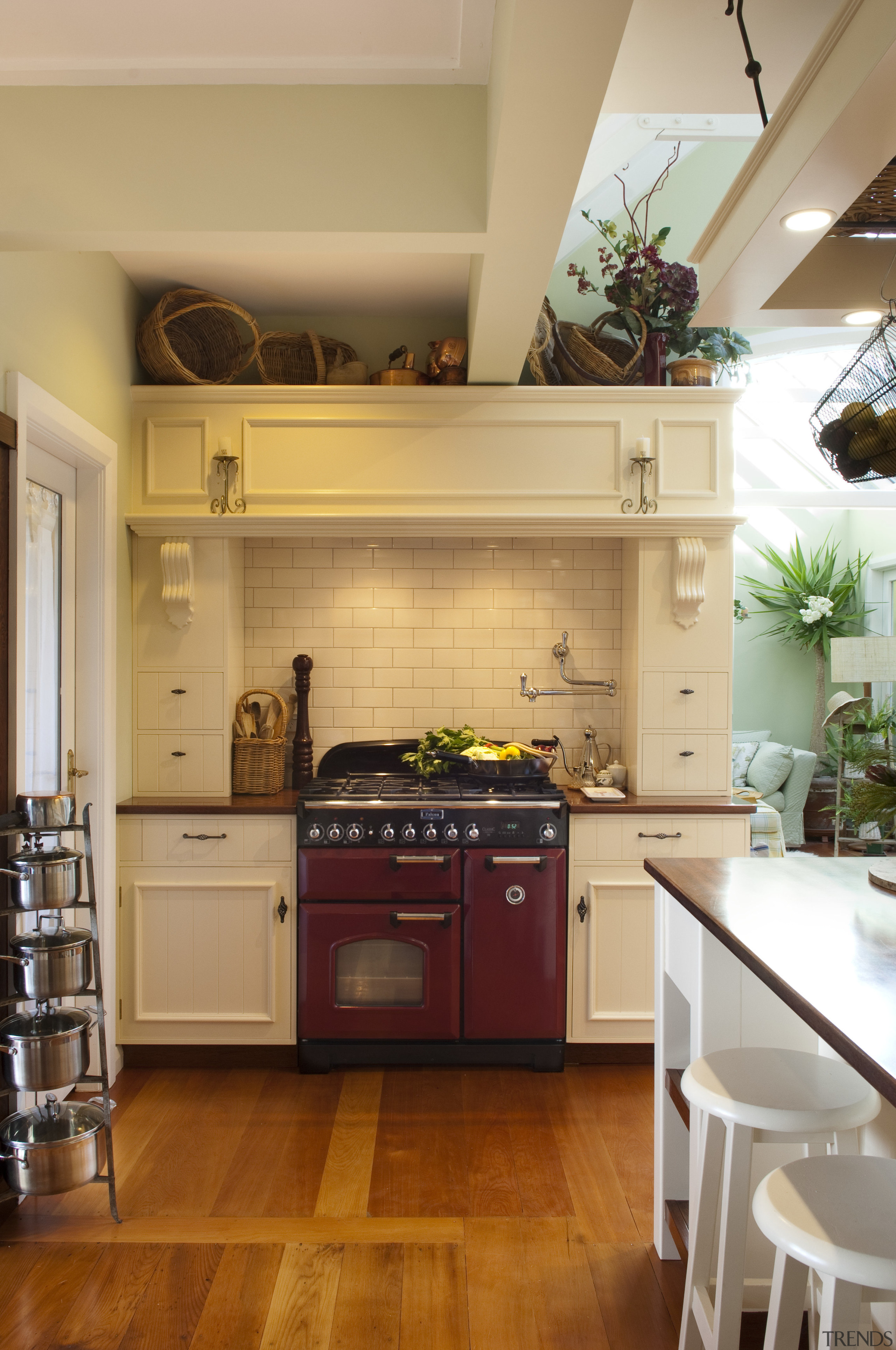 red-fronted cooker with white traditional surround cabinetry, countertop, cuisine classique, floor, flooring, hardwood, home, interior design, kitchen, laminate flooring, living room, room, wood, wood flooring, orange, brown