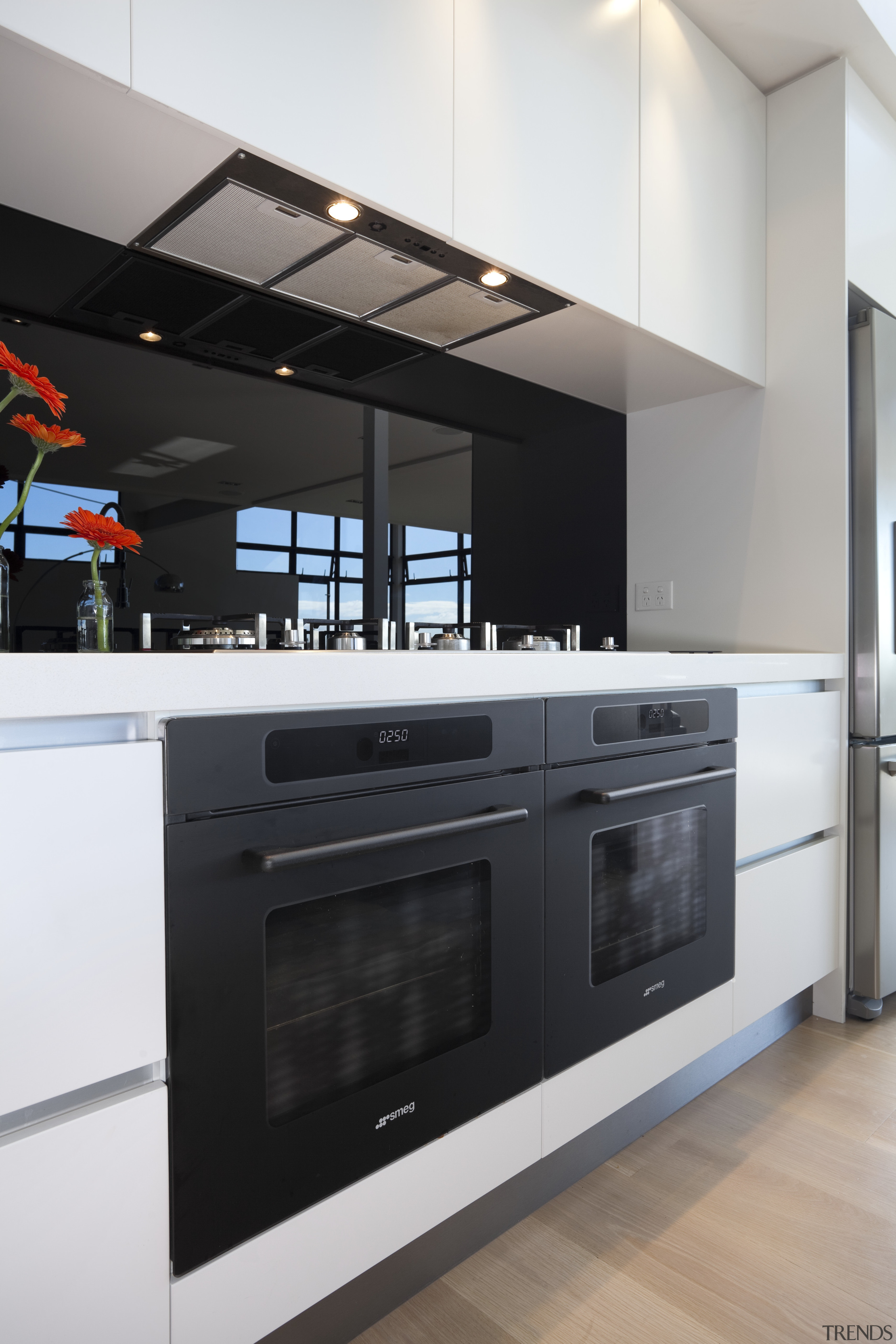 View of contemporary kitchen with white cupboards and cabinetry, countertop, gas stove, home appliance, interior design, kitchen, kitchen appliance, kitchen stove, major appliance, microwave oven, oven, black, gray, white