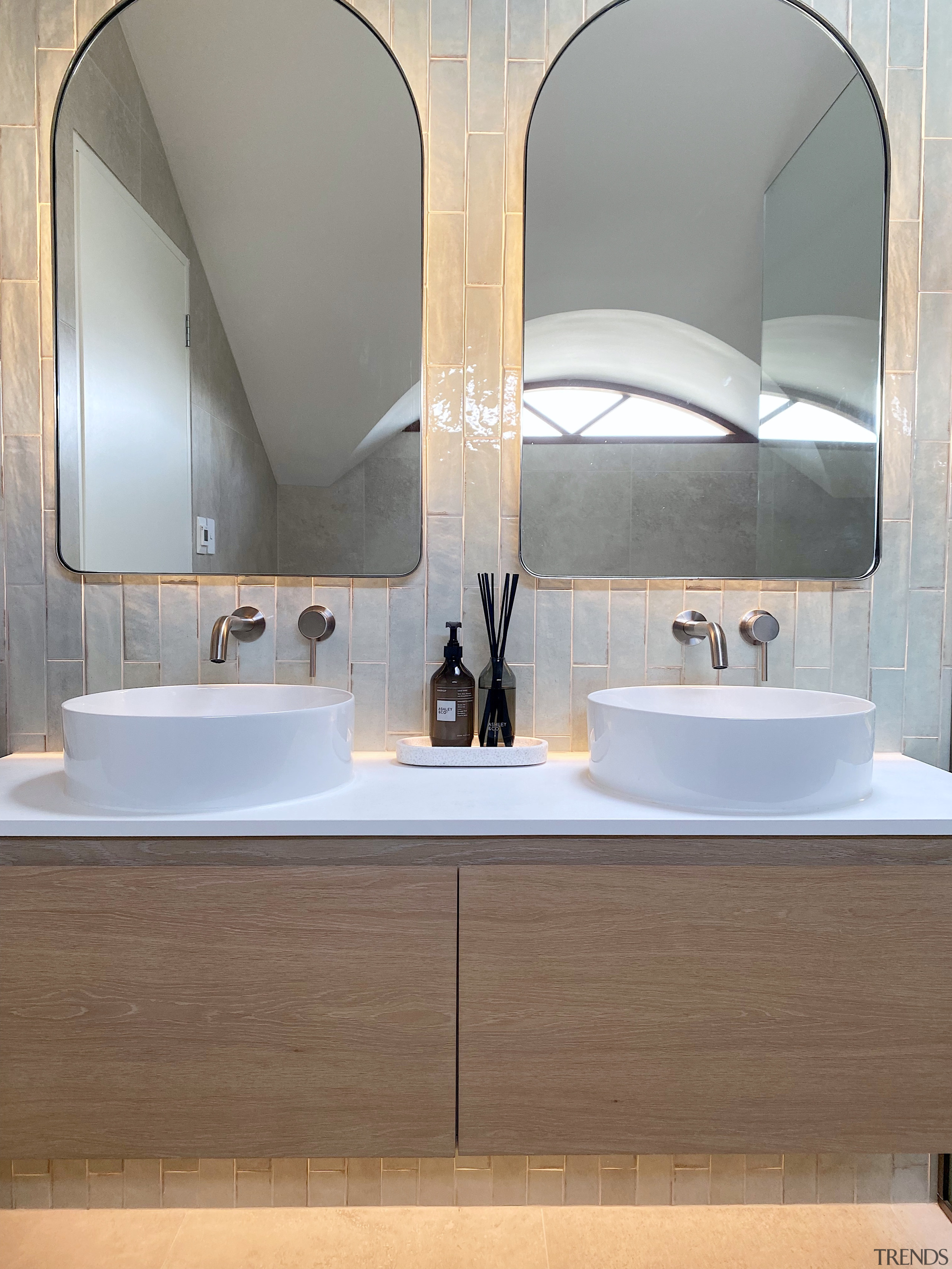 The backlit mirrors and under-lit vanity create restful 