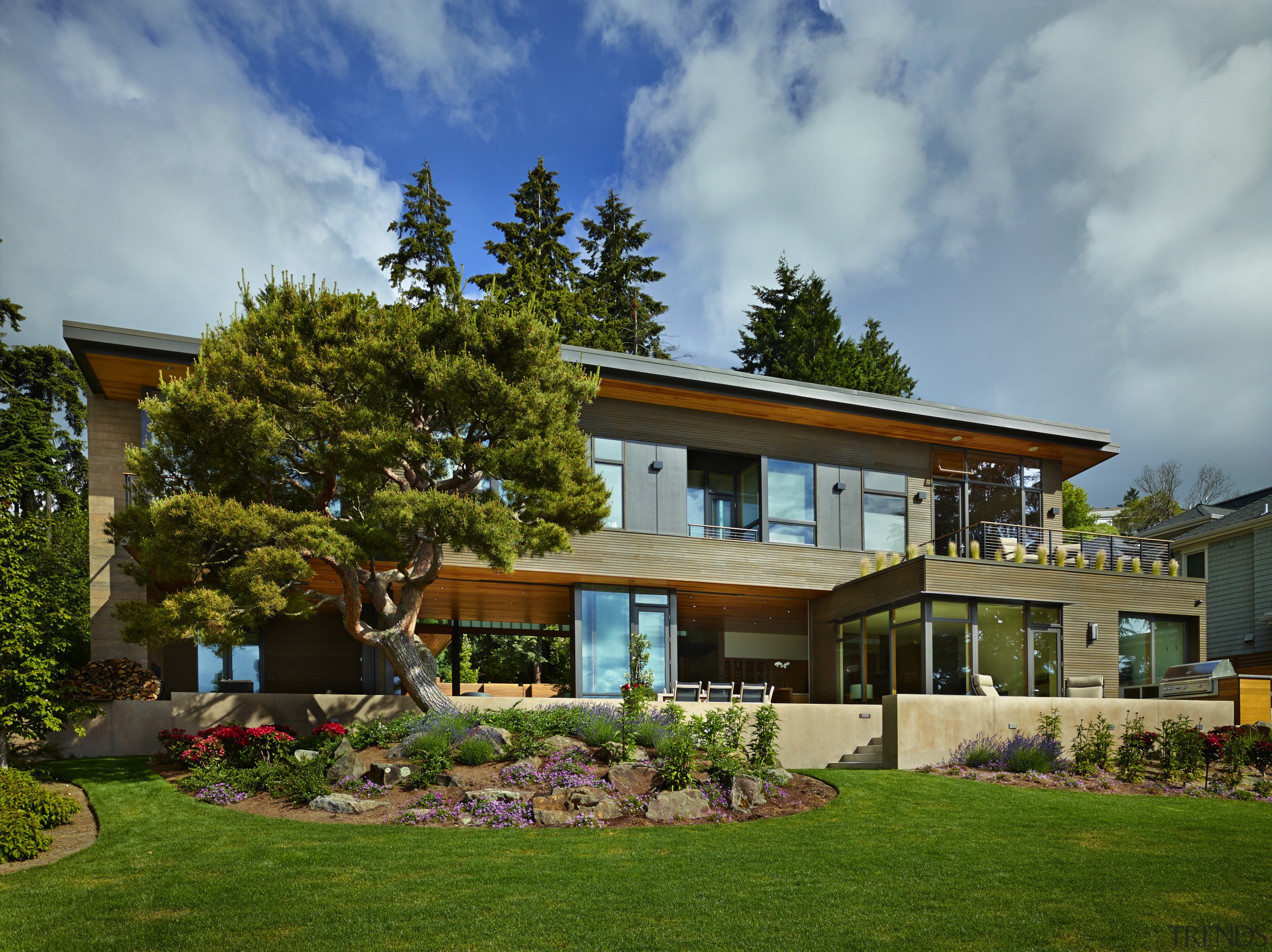 Full-height sliding doors maximise indoor-outdoor connections in this backyard, cottage, elevation, estate, facade, grass, home, house, landscape, landscaping, lawn, property, real estate, residential area, villa, yard, brown, gray