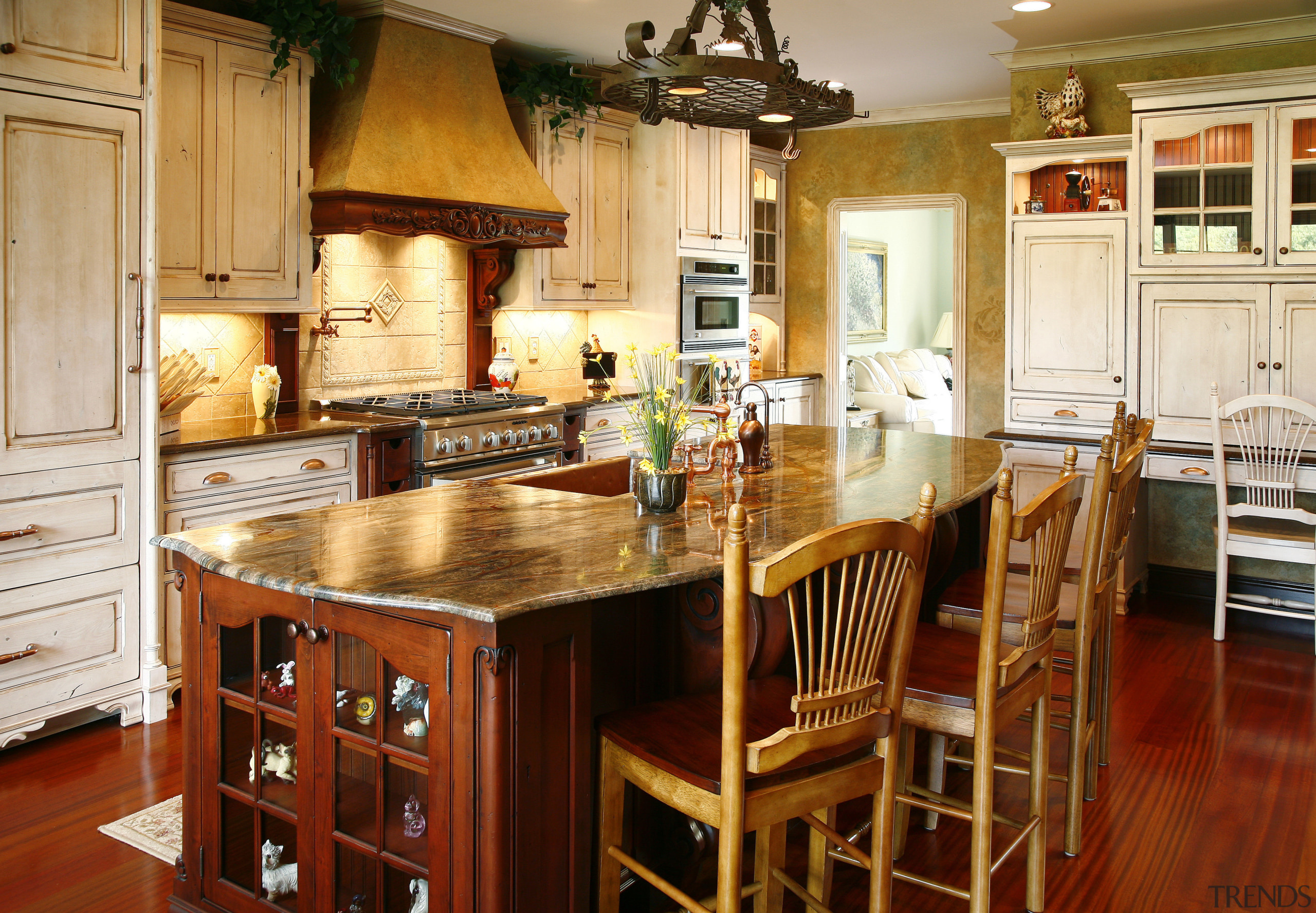 The Island's select alder cabinetry is paired with cabinetry, countertop, cuisine classique, dining room, furniture, hardwood, interior design, kitchen, room, table, wood, red, orange