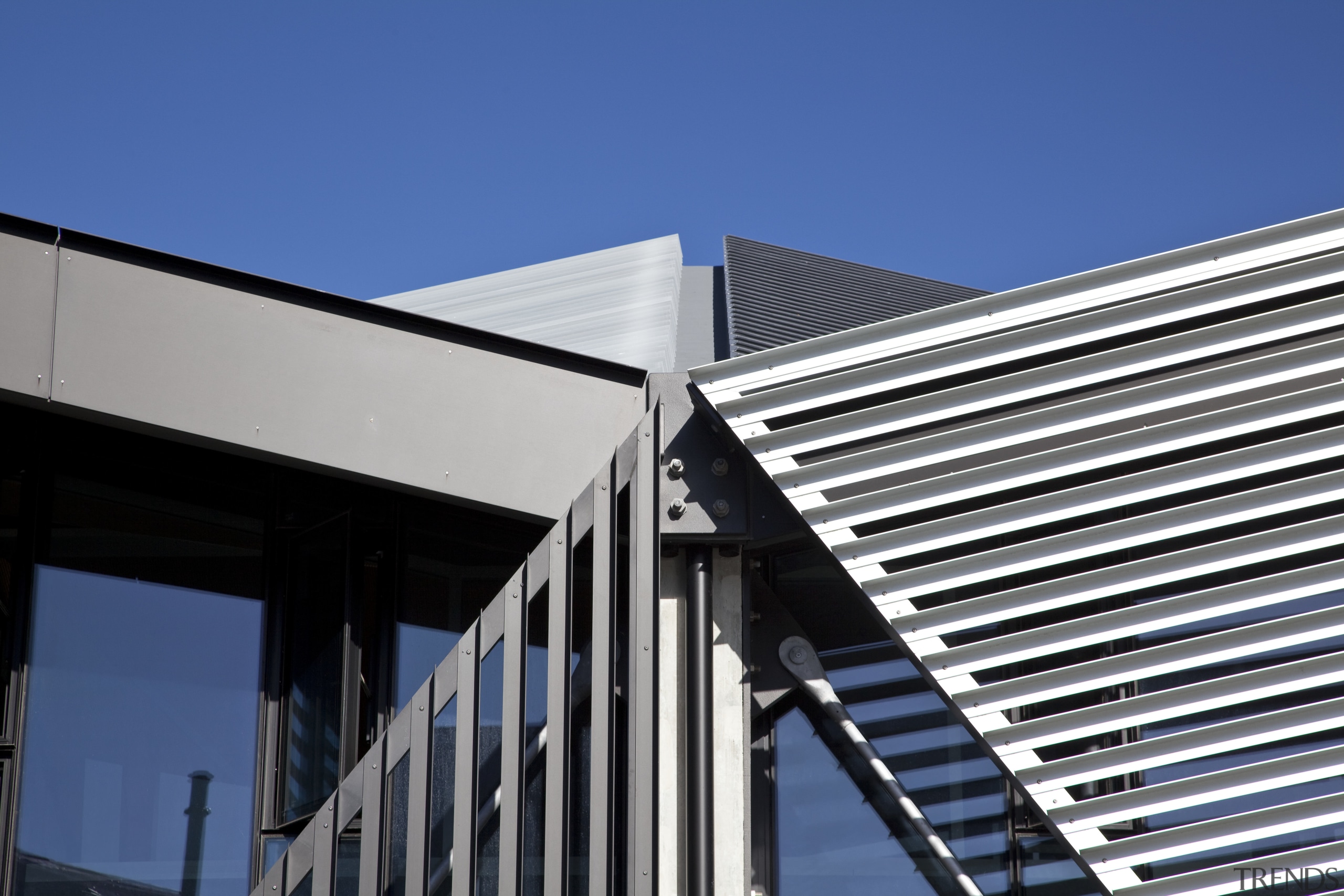 View of roofing and heating systems supplied by architecture, building, commercial building, corporate headquarters, daylighting, daytime, facade, house, line, roof, sky, structure, blue