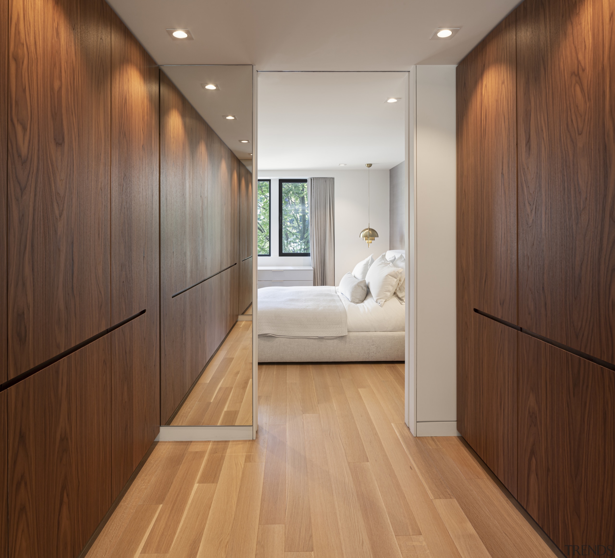 The master dressing room includes minimalist handleless wardrobes 