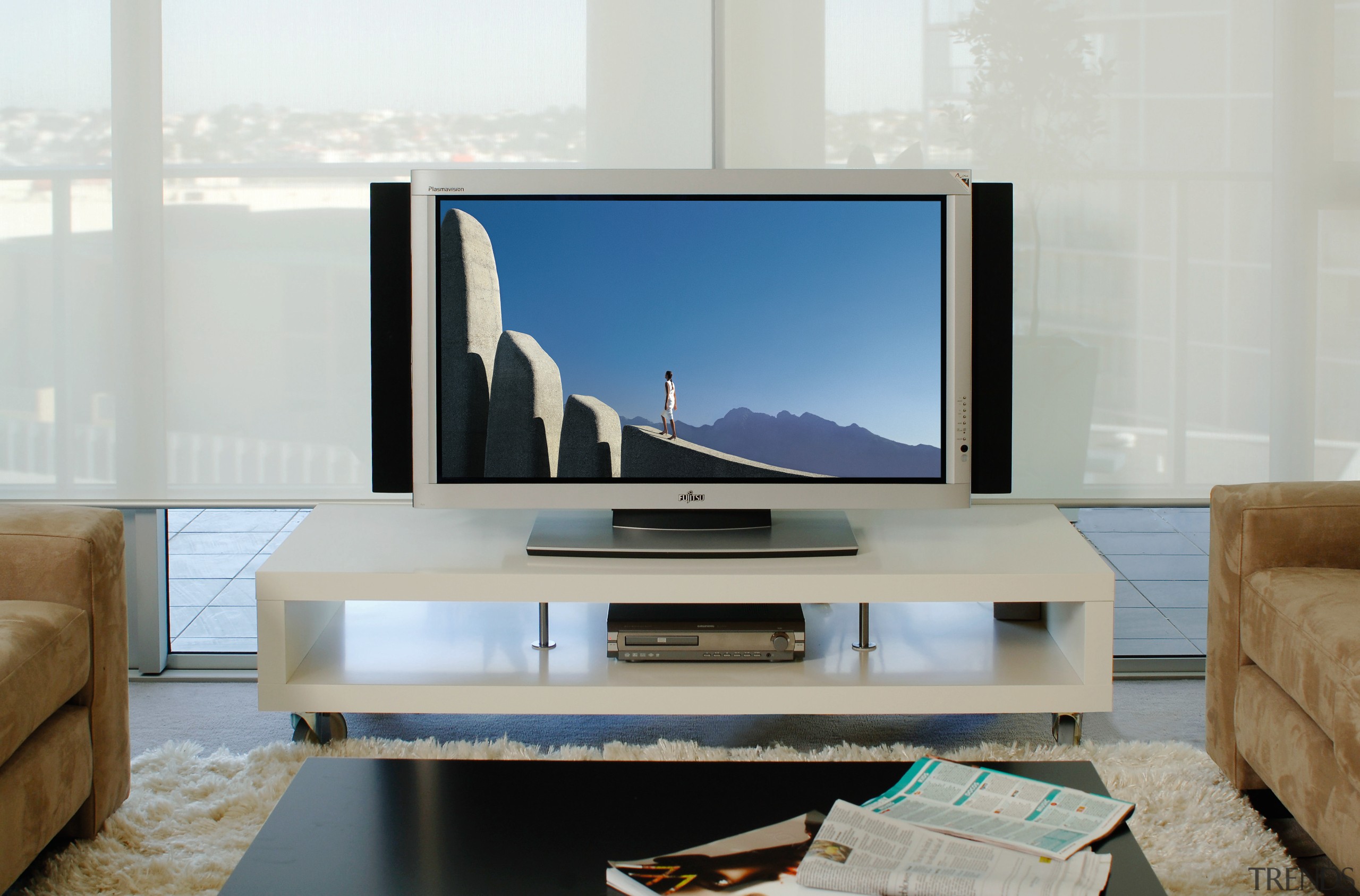 View of plasma screen on white box shaped display device, flat panel display, furniture, interior design, media, multimedia, product design, table, television, gray, white