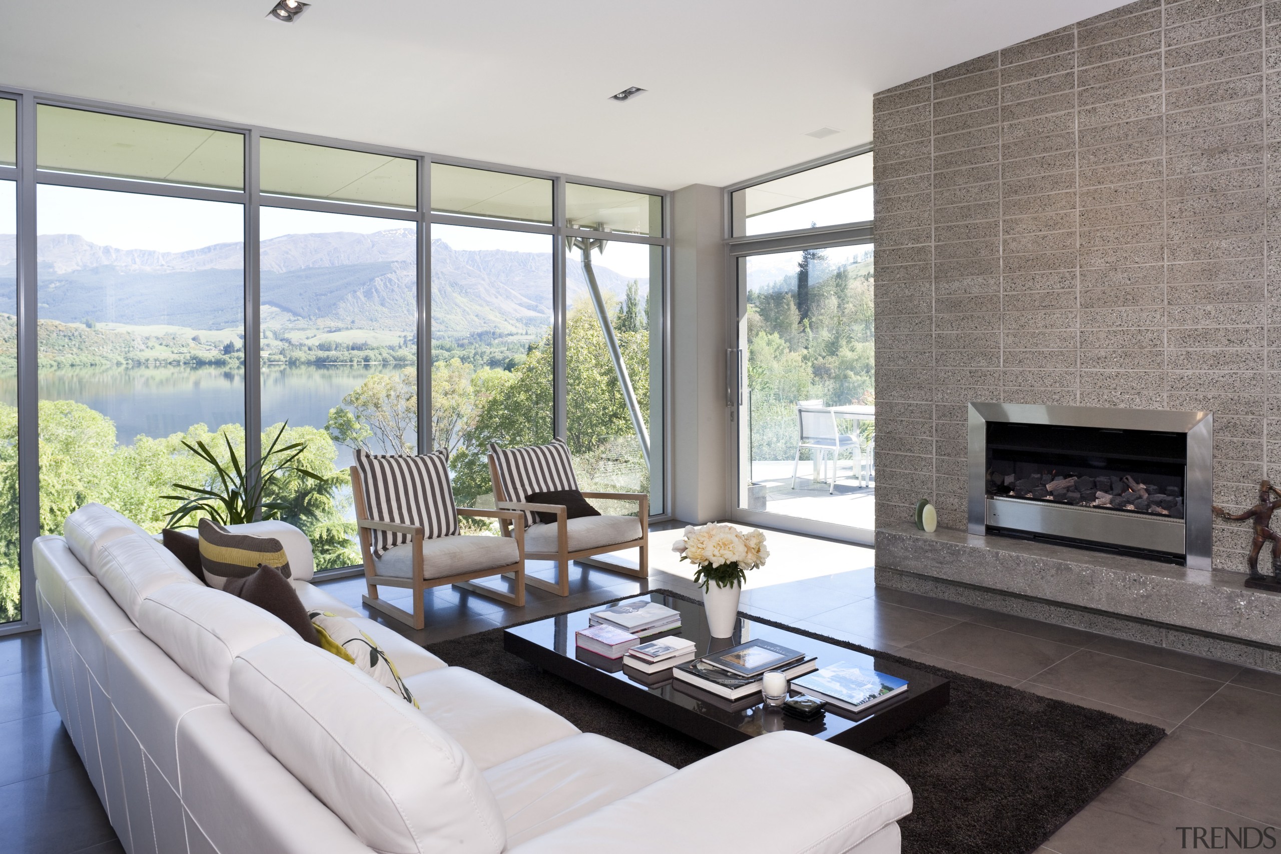 View of kitchen and living area featuring light architecture, hearth, home, house, interior design, living room, property, real estate, window, white, gray