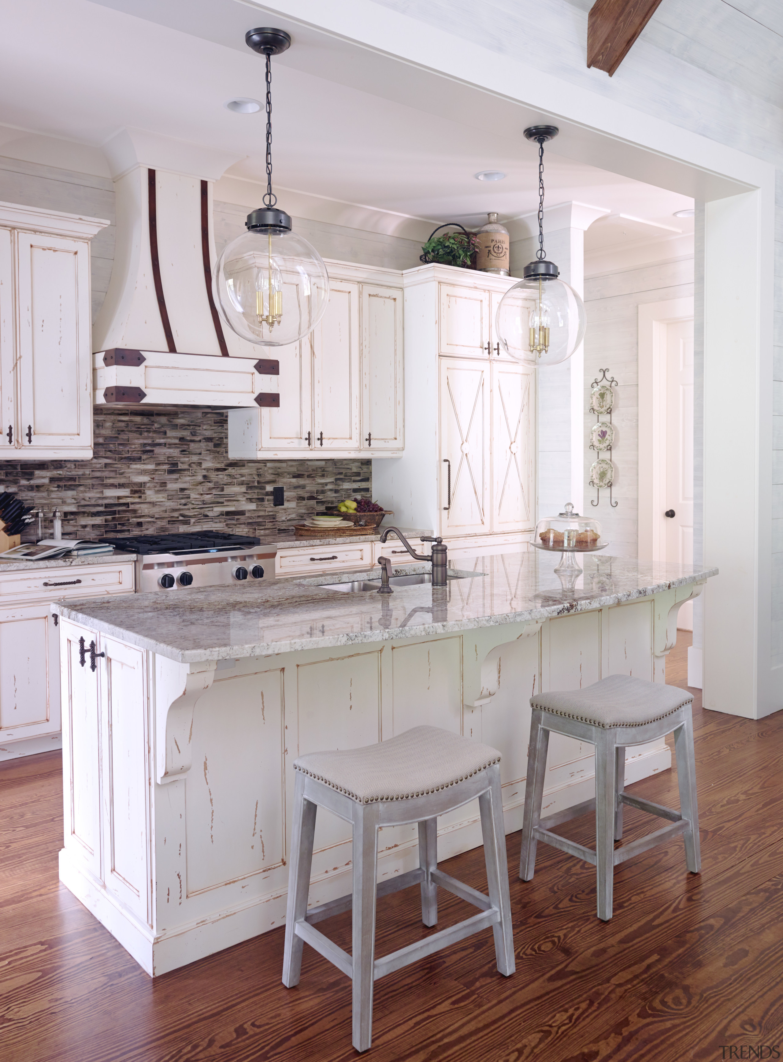 Distressed paint with the wood showing through helps cabinetry, countertop, cuisine classique, dining room, floor, flooring, furniture, hardwood, home, interior design, kitchen, room, table, wood flooring, gray, white