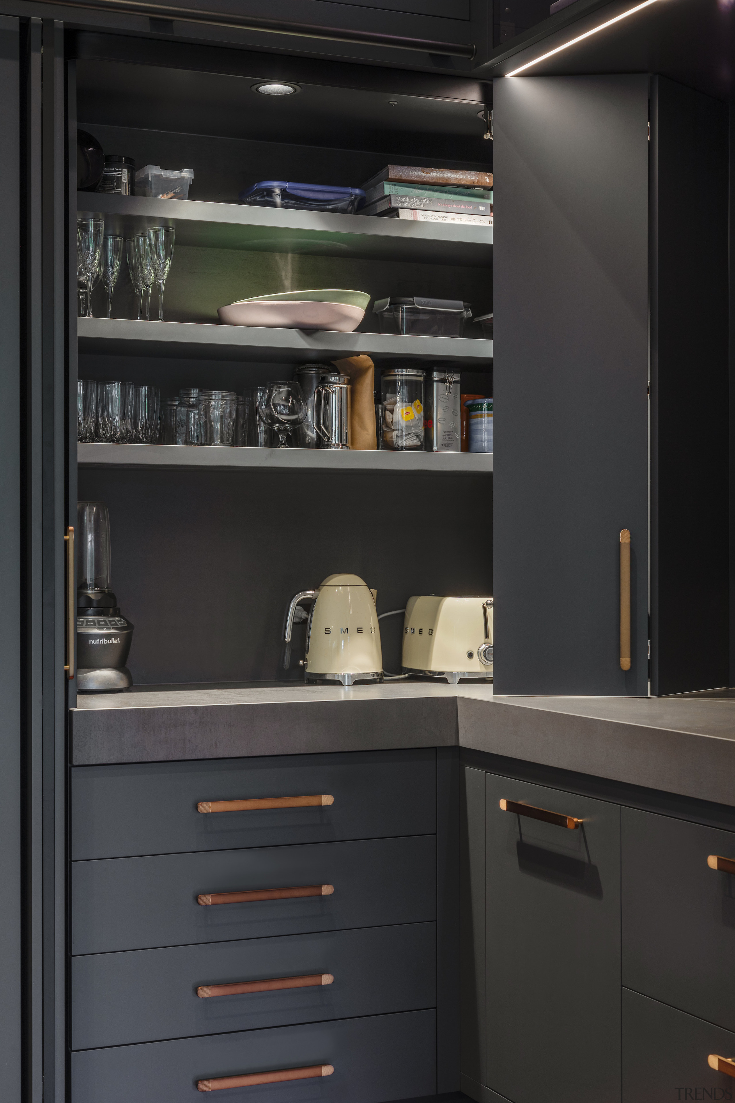 Bi-fold doors reveal the in-cabinet scullery. 