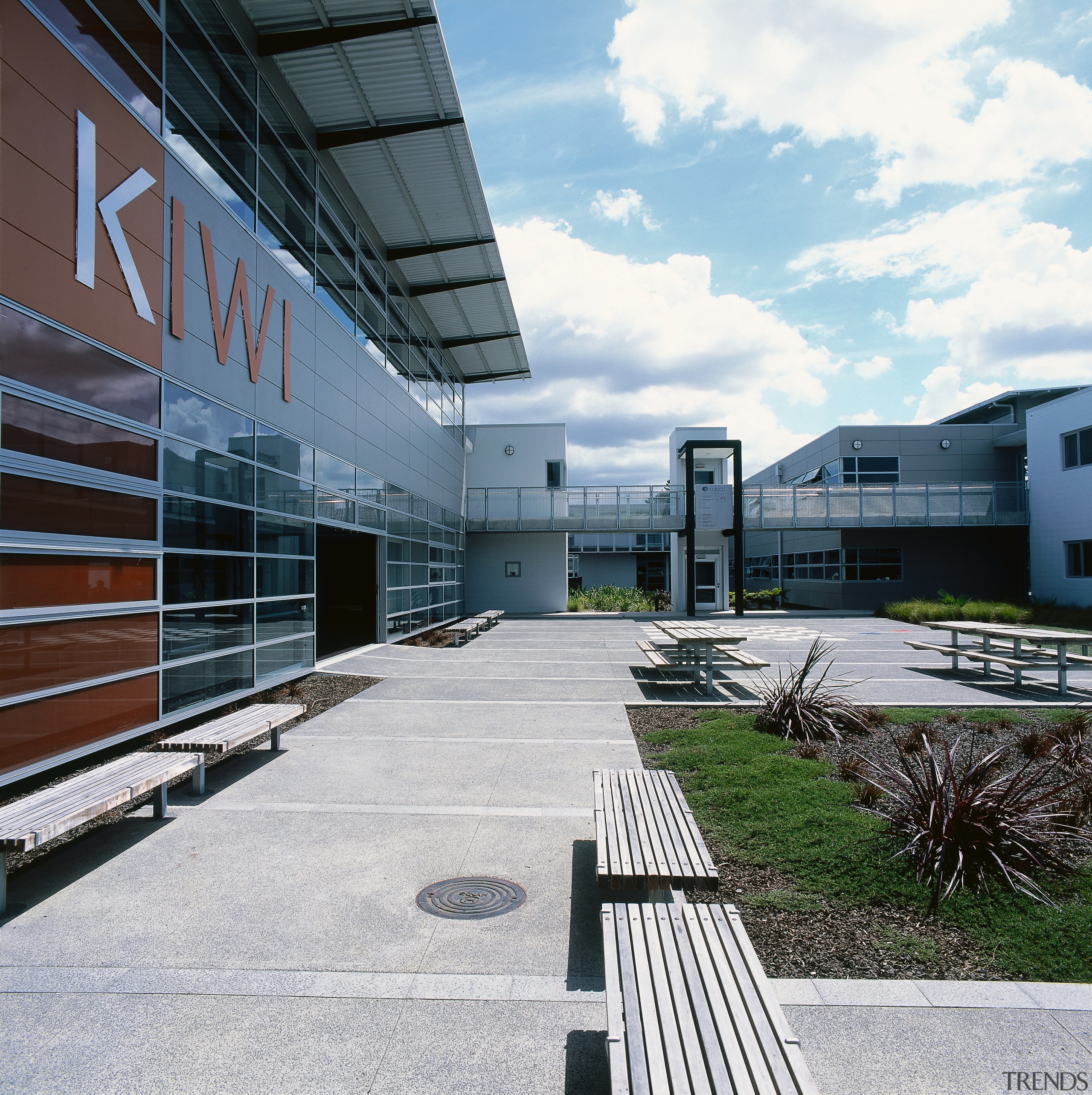 Courtyard area with landscaping and seating outside school architecture, building, commercial building, corporate headquarters, facade, headquarters, mixed use, real estate, residential area, sky, structure, urban design, white