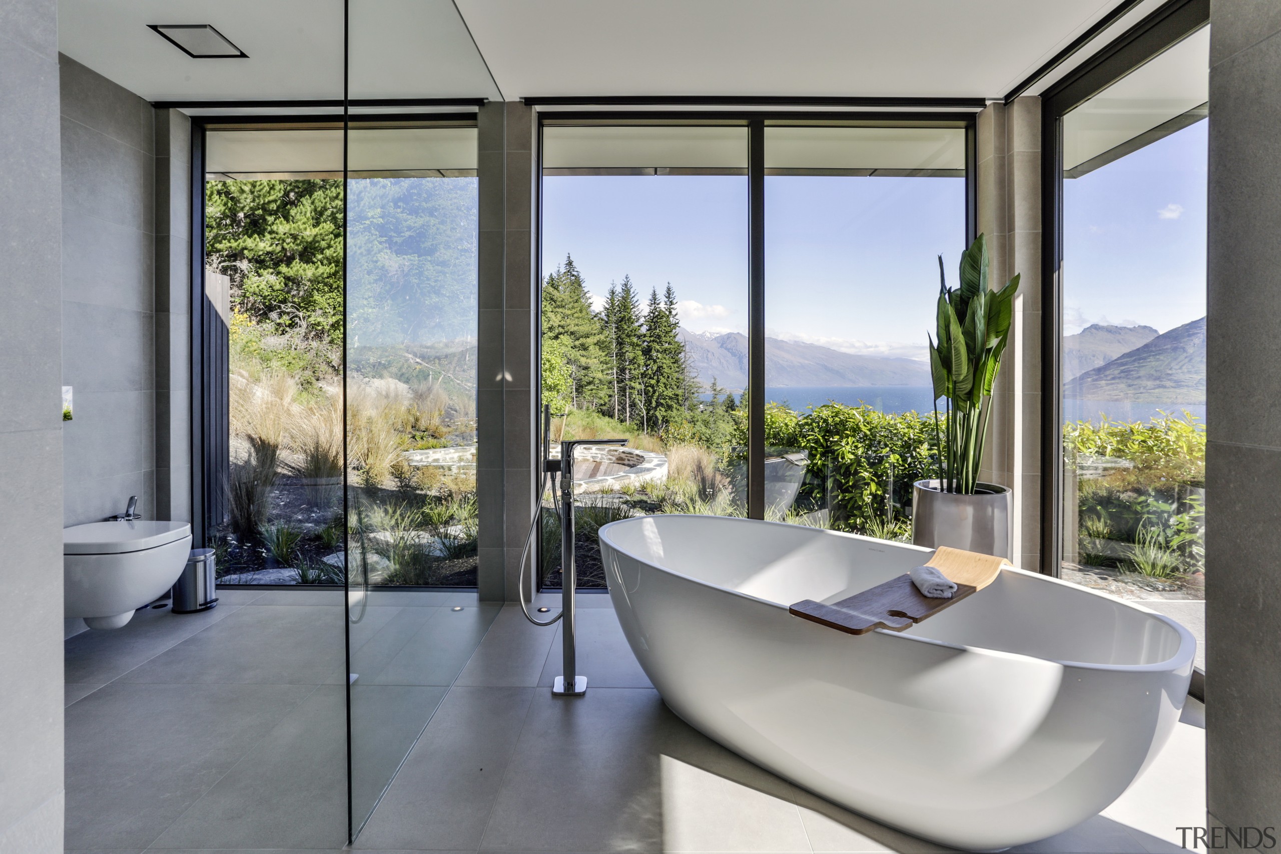 This sculptural tub sits in its own glass architecture, house, interior design, real estate, window, gray