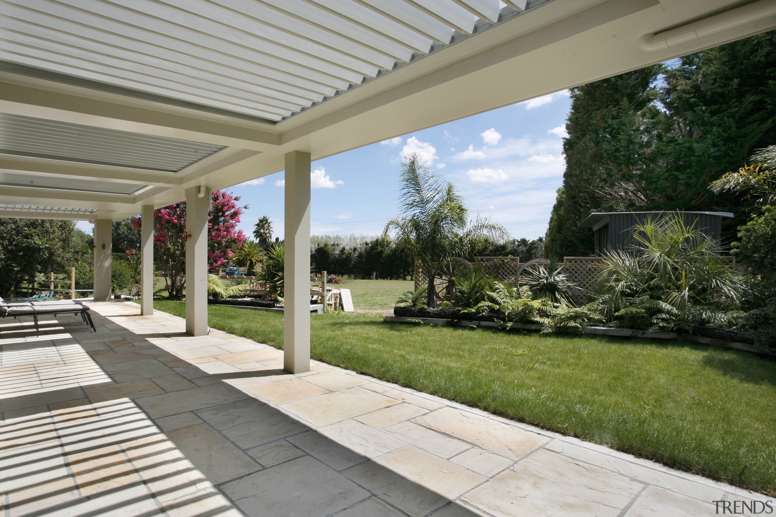 View of natural stone pavers supplied by Jagas backyard, estate, grass, home, house, landscape, landscaping, outdoor structure, patio, property, real estate, walkway, yard, gray