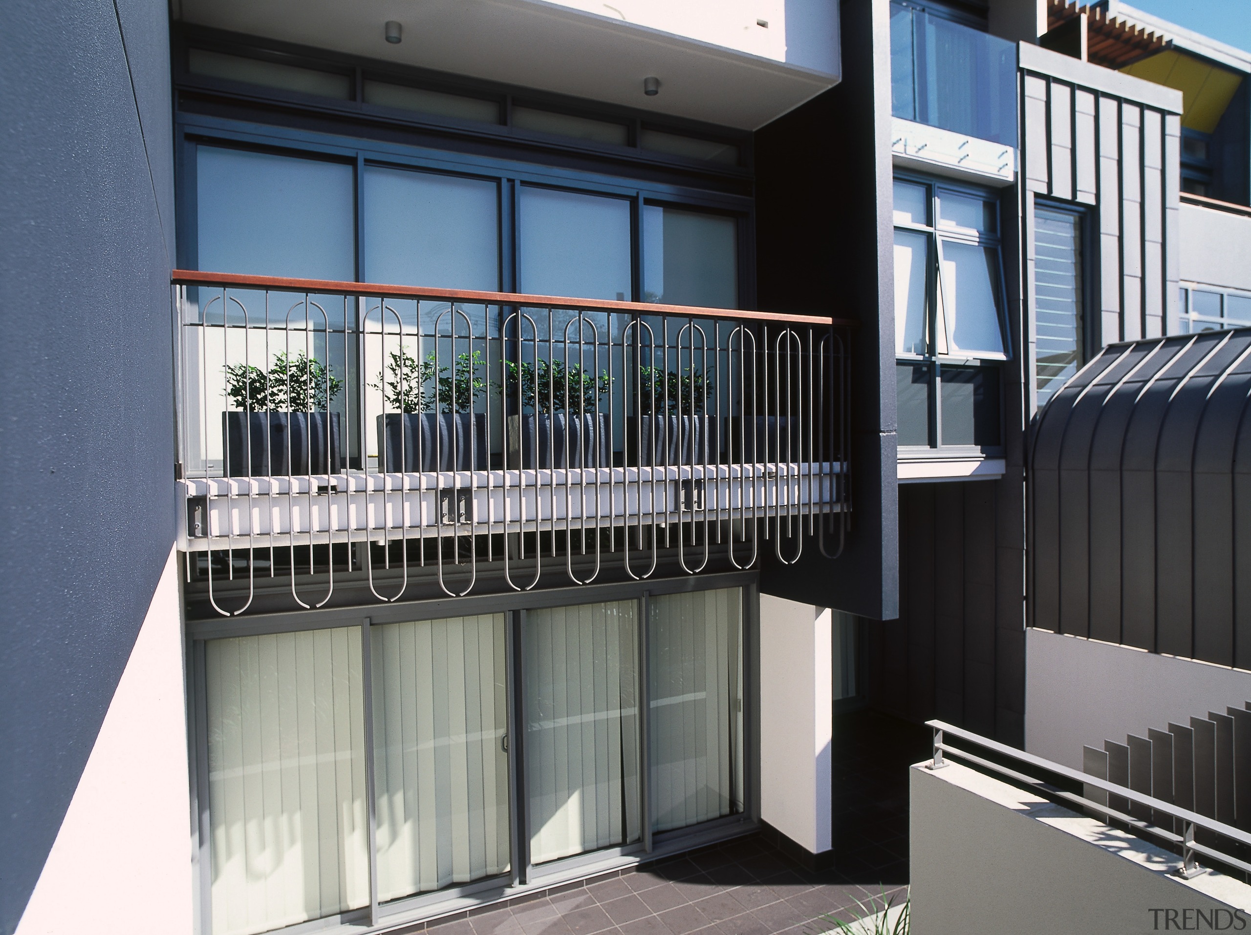 A view of an iron deck railing. - architecture, balcony, building, condominium, facade, glass, handrail, house, property, real estate, residential area, window, black, gray