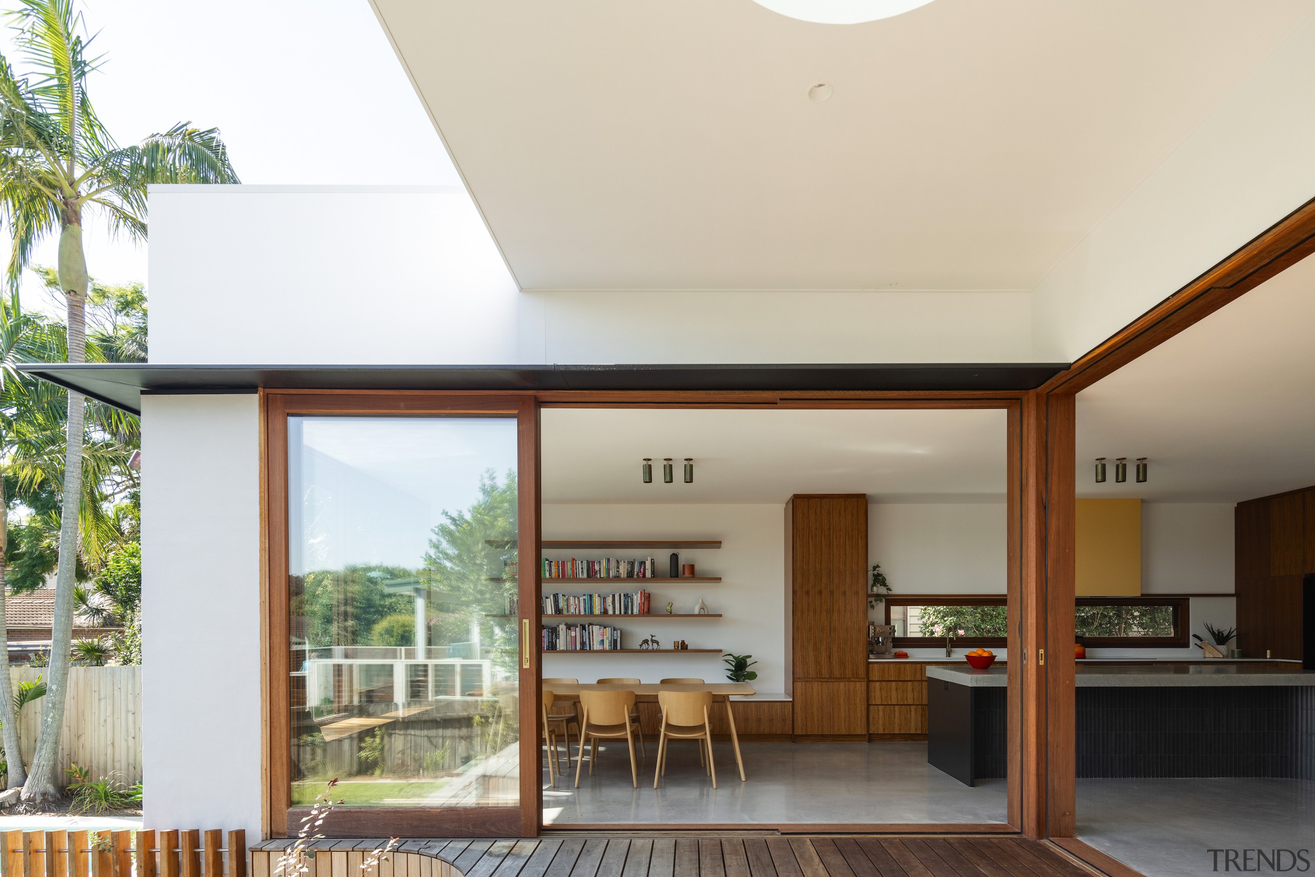 Oversized glass doors open onto the north-facing rear 
