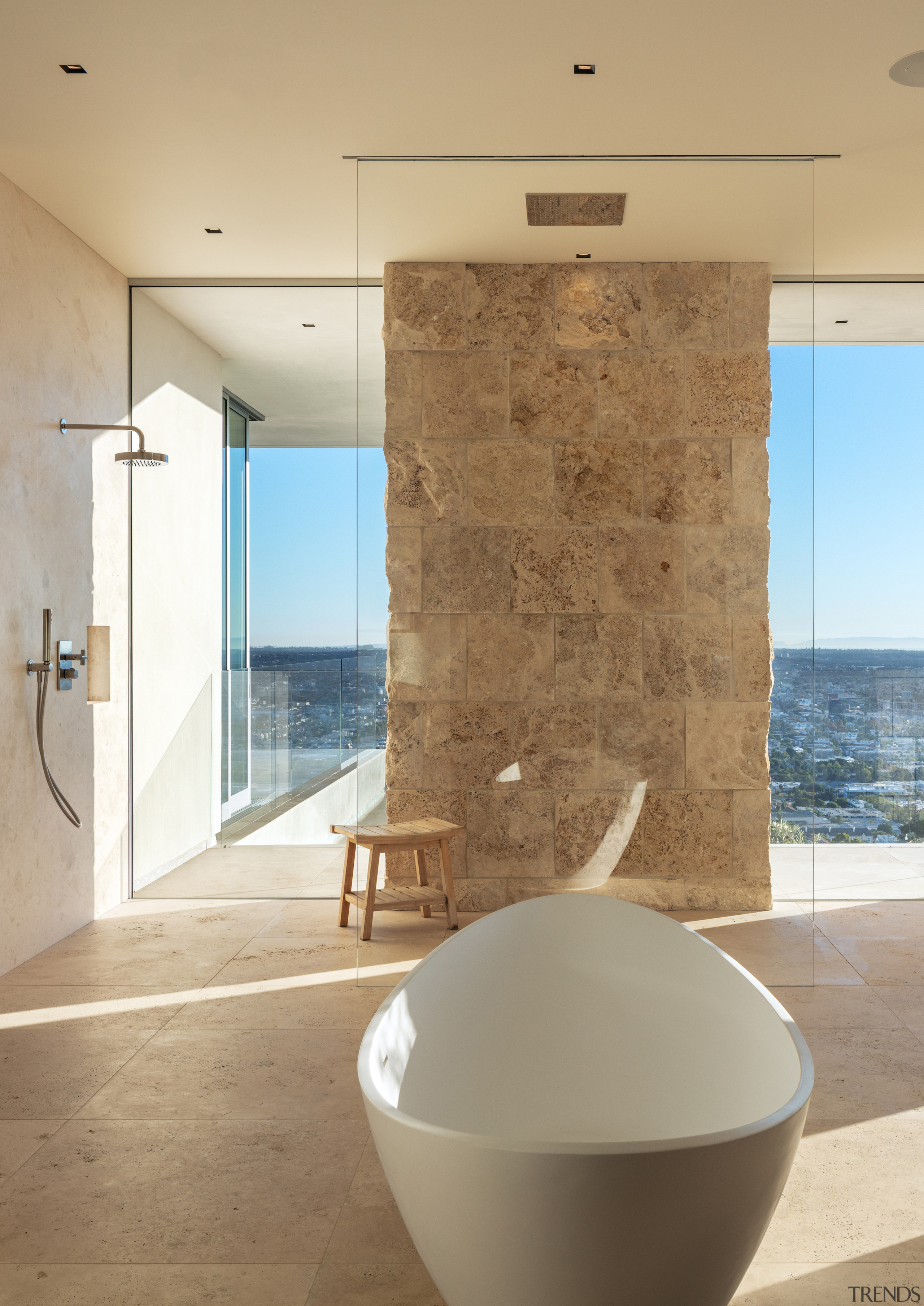 Stone blocks and glass semi-enclose the understated shower 