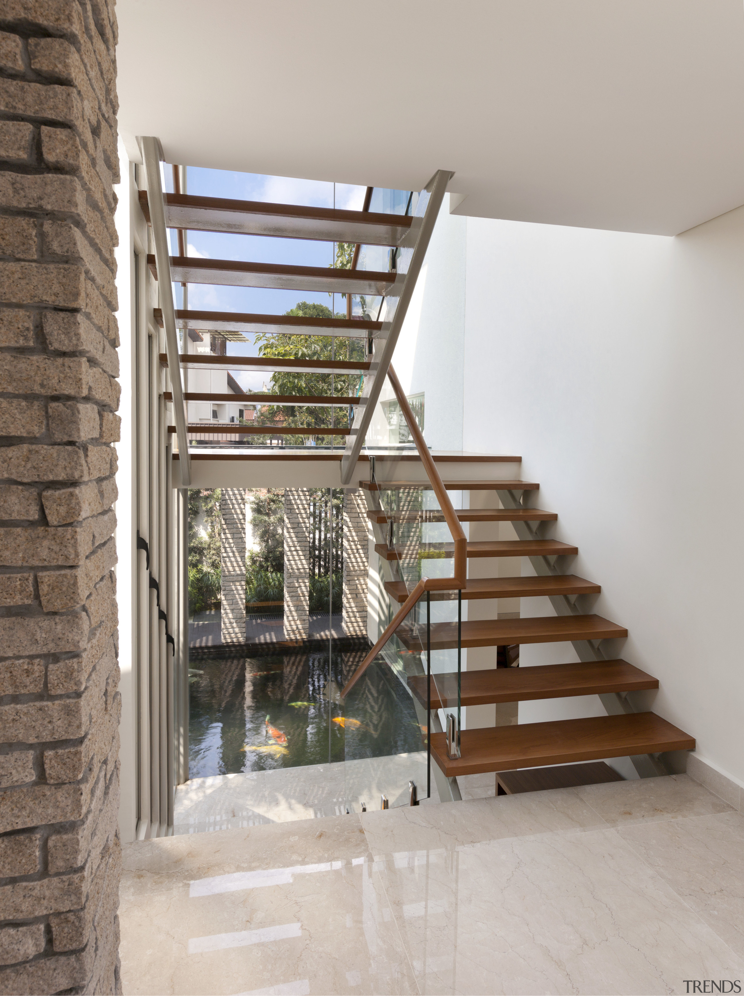 A fully glazed stairwell overlooks the koi pond baluster, daylighting, estate, handrail, property, real estate, stairs, gray