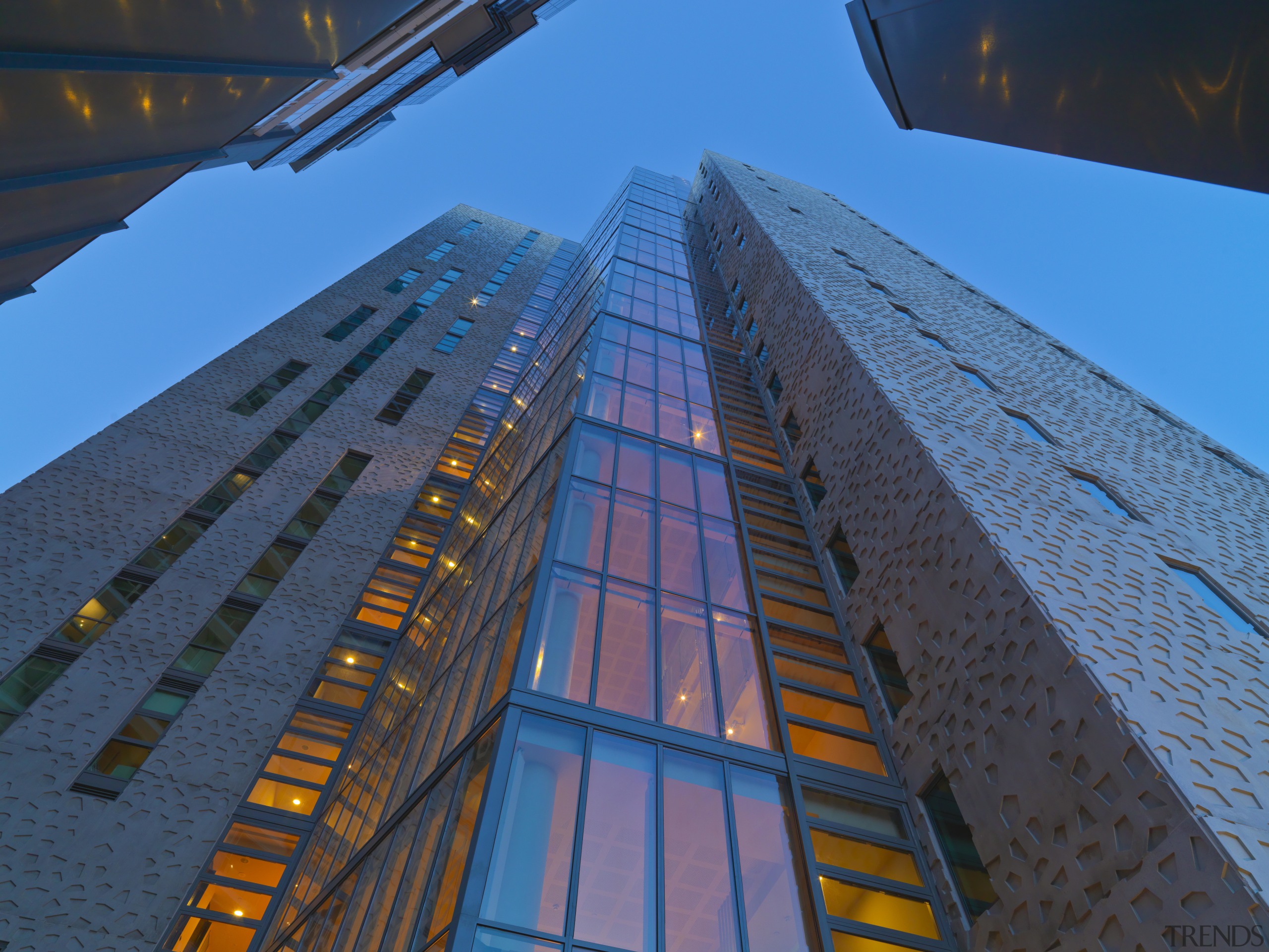 Exterior view of the Triptych residential tower in architecture, building, city, daylighting, daytime, facade, landmark, line, metropolis, metropolitan area, sky, skyscraper, structure, symmetry, tower, tower block, urban area, blue, teal