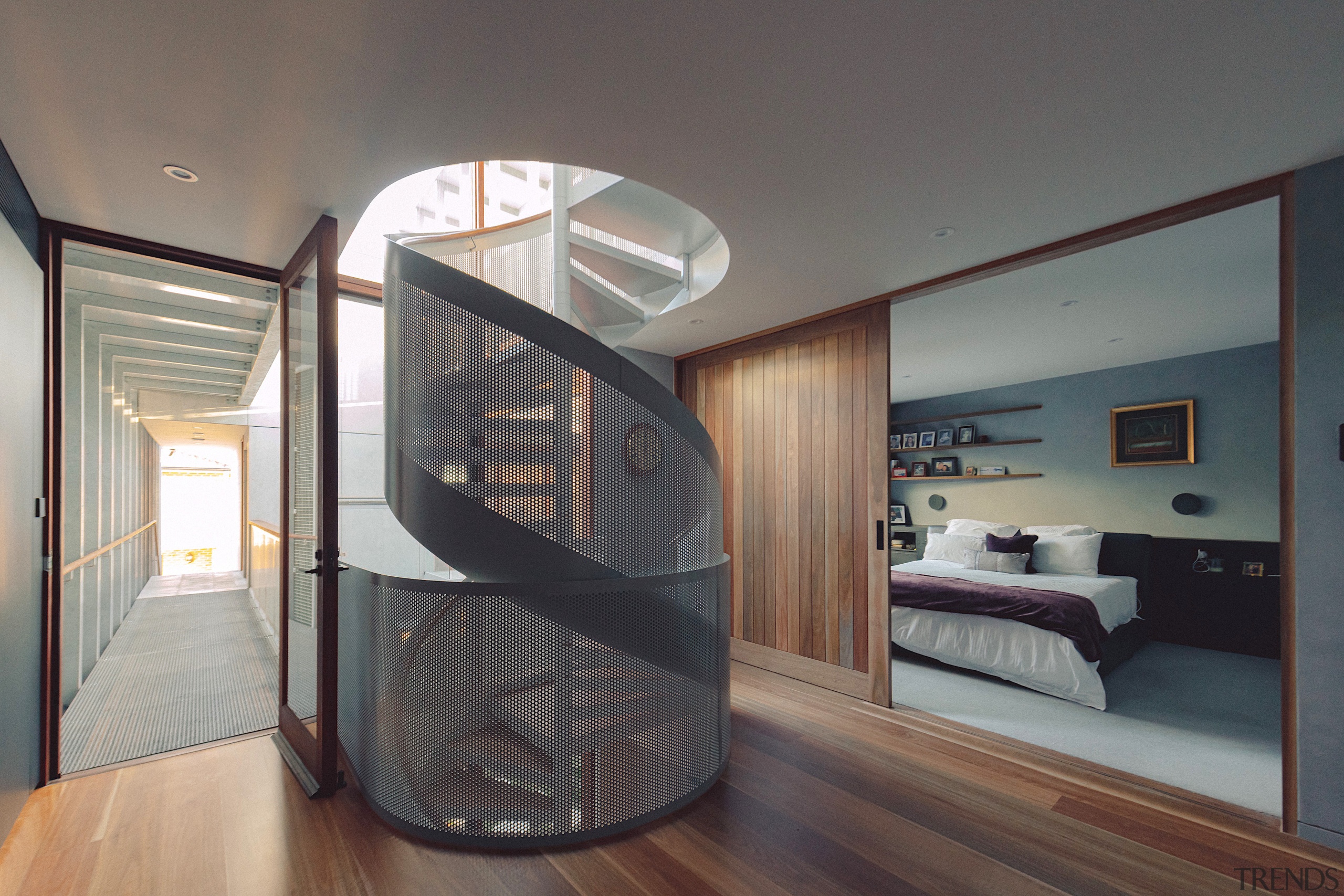 The central light-bringing circulation staircase with master bedroom 