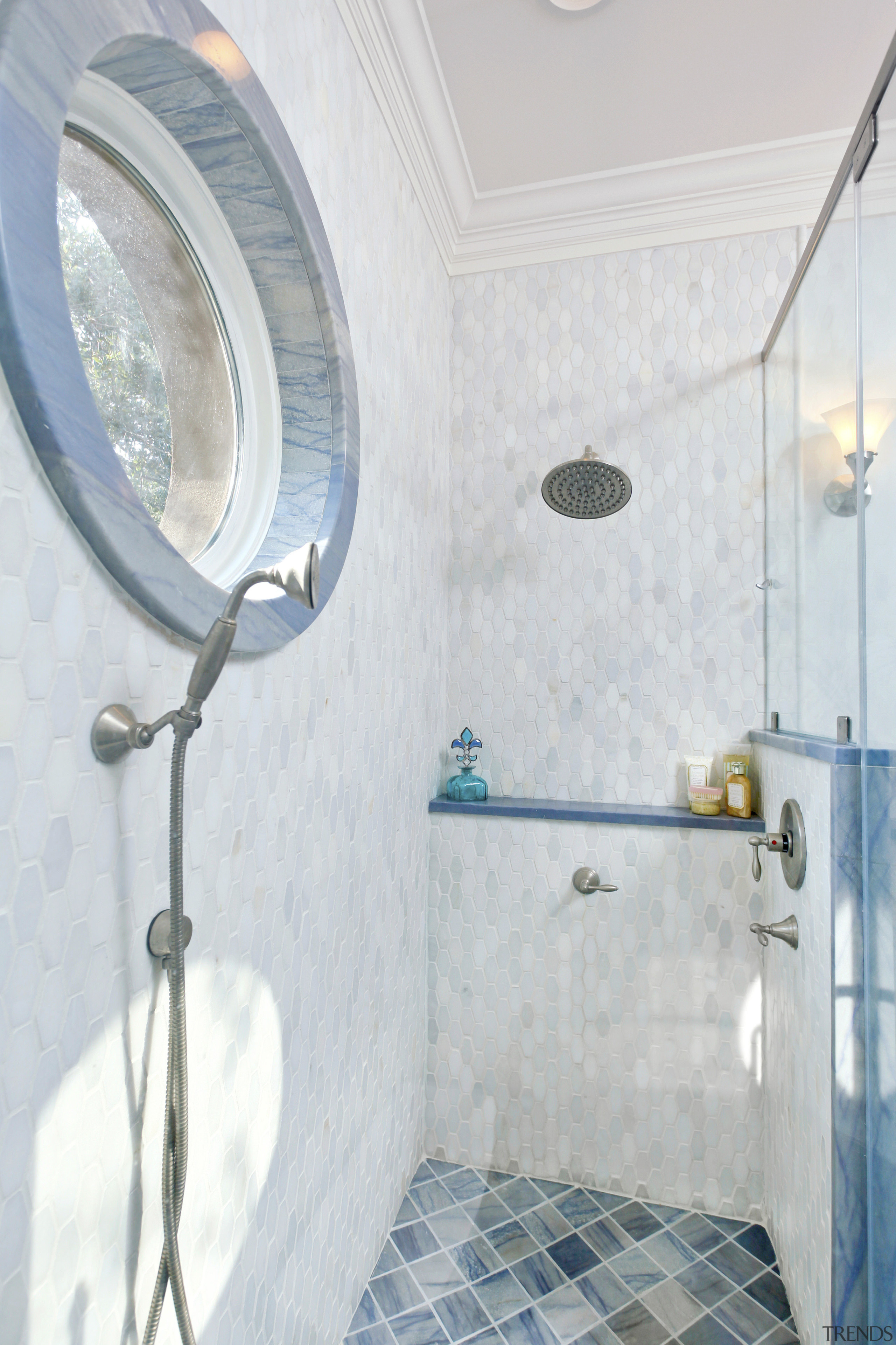 This bathroom by Cheryl Kees Clendenon manipulates color, bathroom, blue, ceiling, daylighting, floor, home, interior design, plumbing fixture, property, room, tap, tile, wall, white