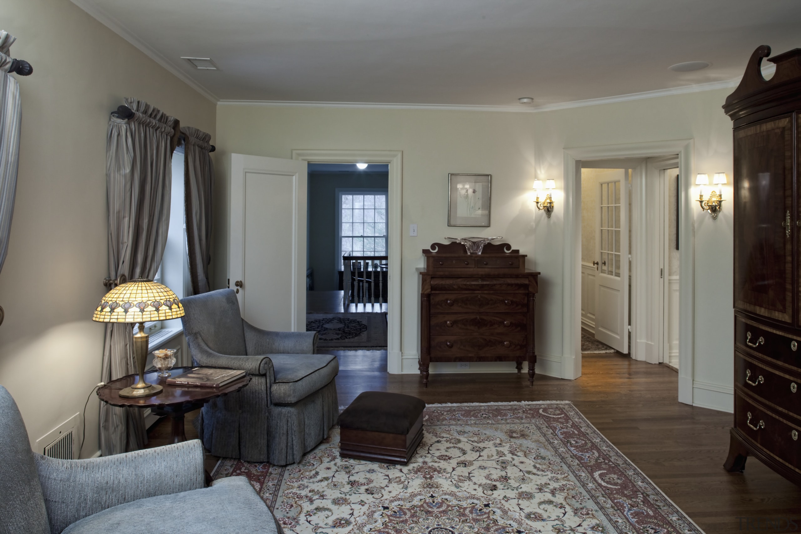 View of the sitting room featuring traditional-styled seating, bedroom, ceiling, estate, floor, flooring, hardwood, home, interior design, living room, property, real estate, room, wall, window, wood, gray, black