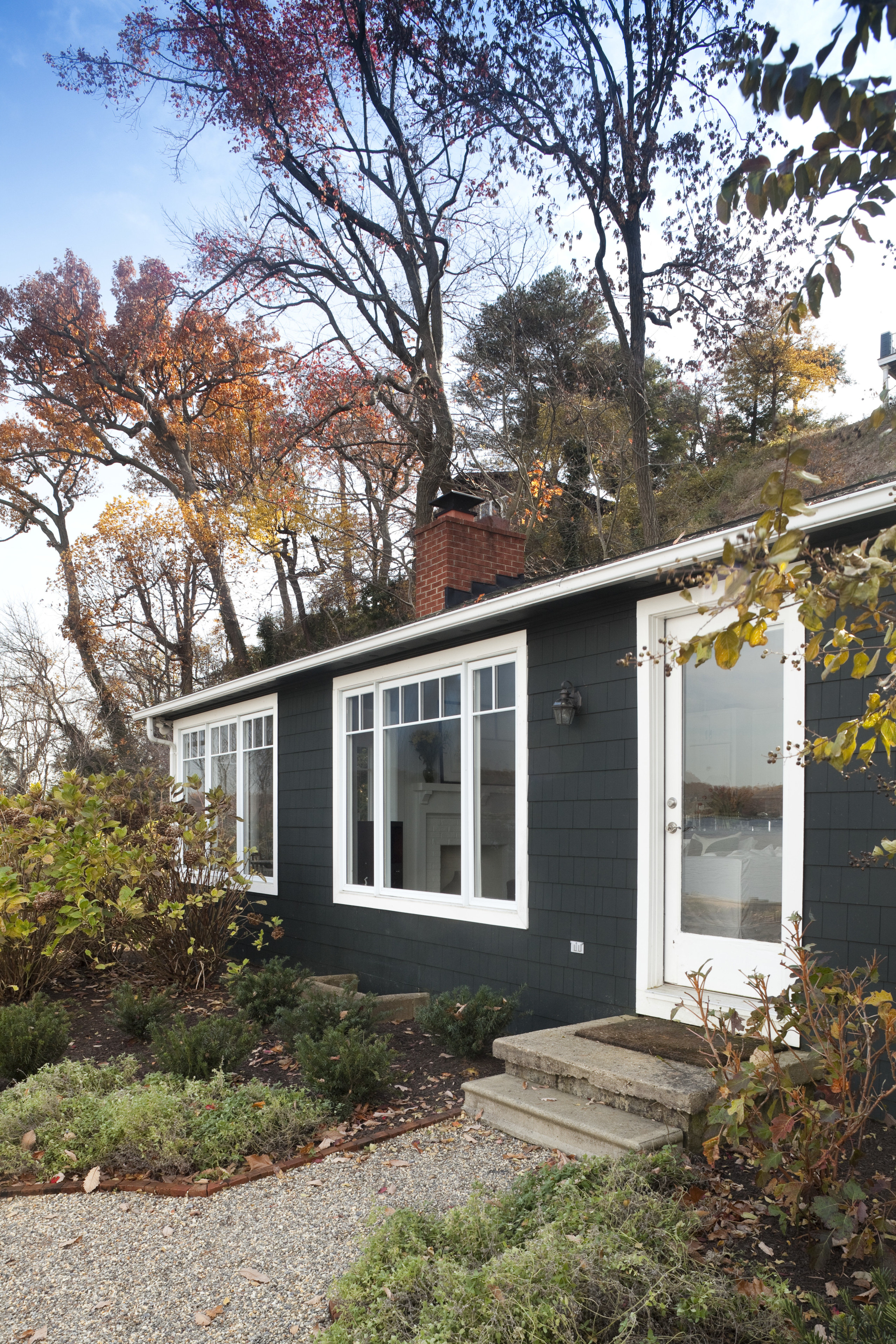 Entrance way to house with grey exterior and architecture, cottage, facade, farmhouse, home, house, outdoor structure, property, real estate, residential area, siding, tree, window, white