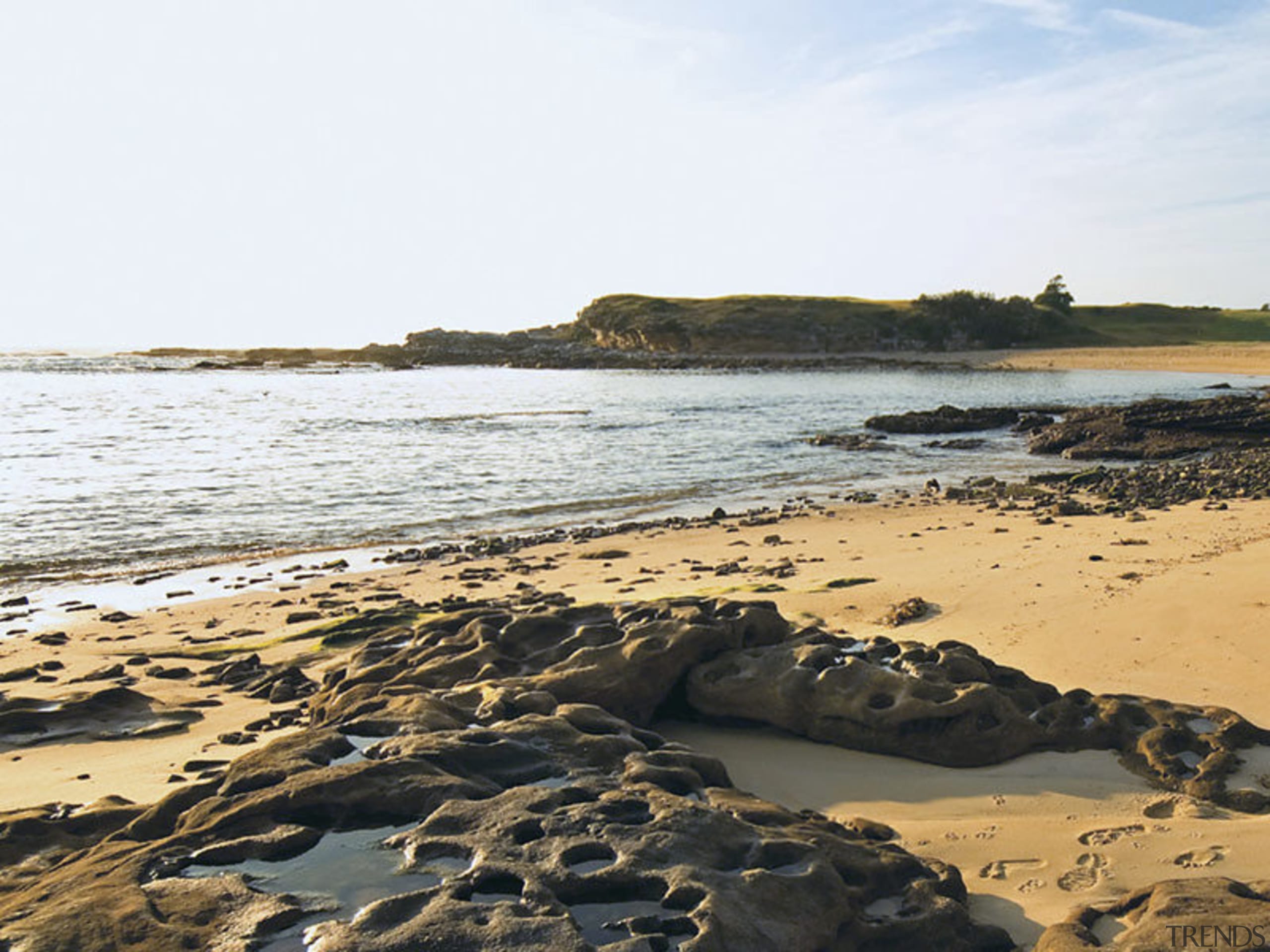 A view of the Coastal beaches located close beach, body of water, coast, coastal and oceanic landforms, headland, horizon, ocean, rock, sand, sea, shore, sky, water, white