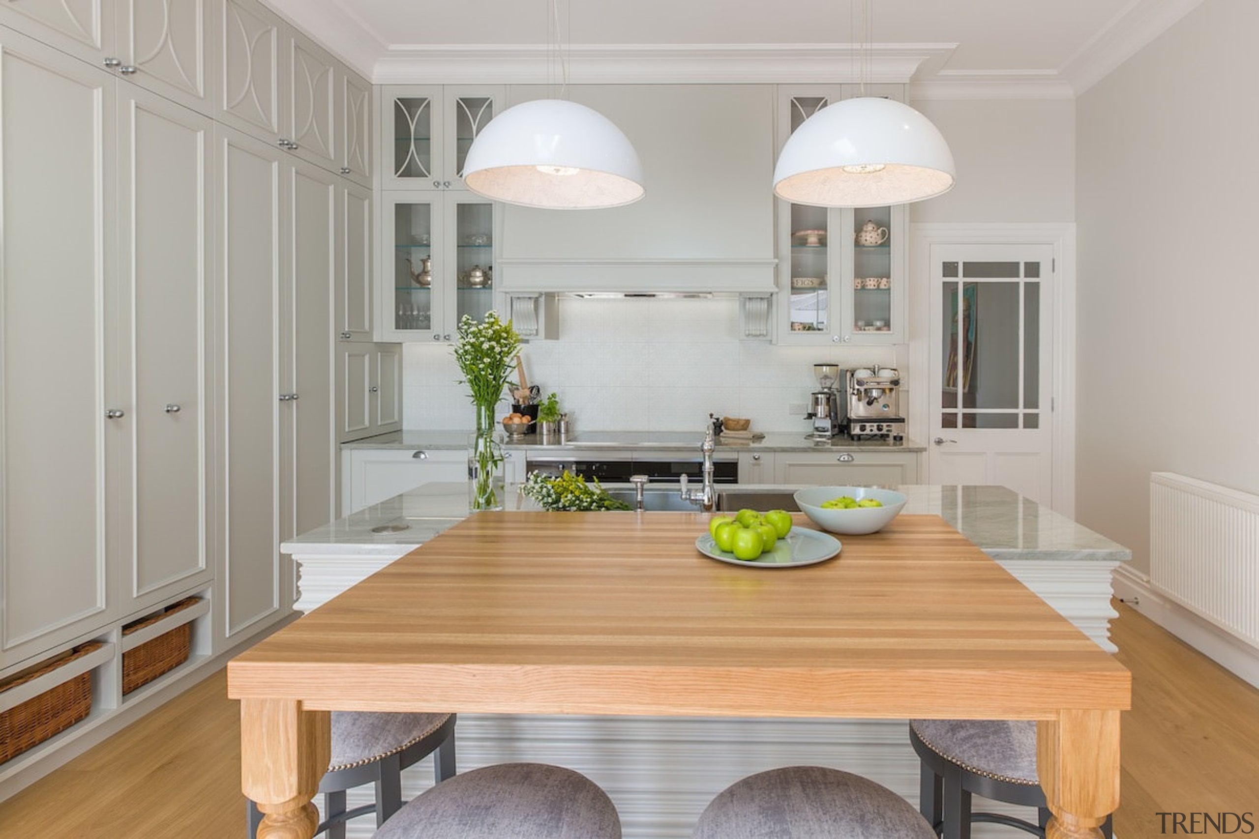 Two hanging lights draw the eye - Two countertop, floor, home, interior design, kitchen, real estate, room, table, wood flooring, gray