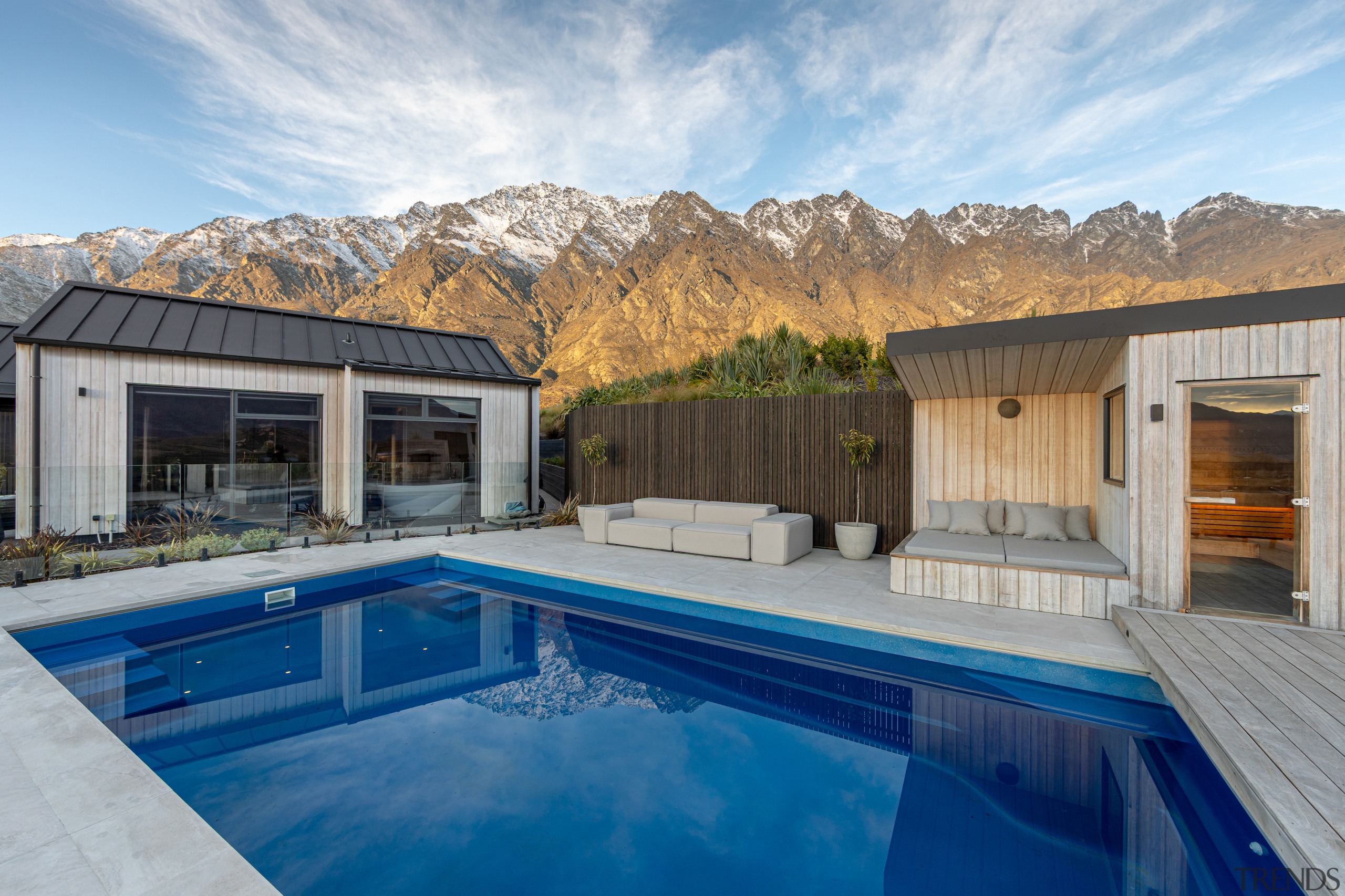 Sheltered poolside seating with sauna at right. 