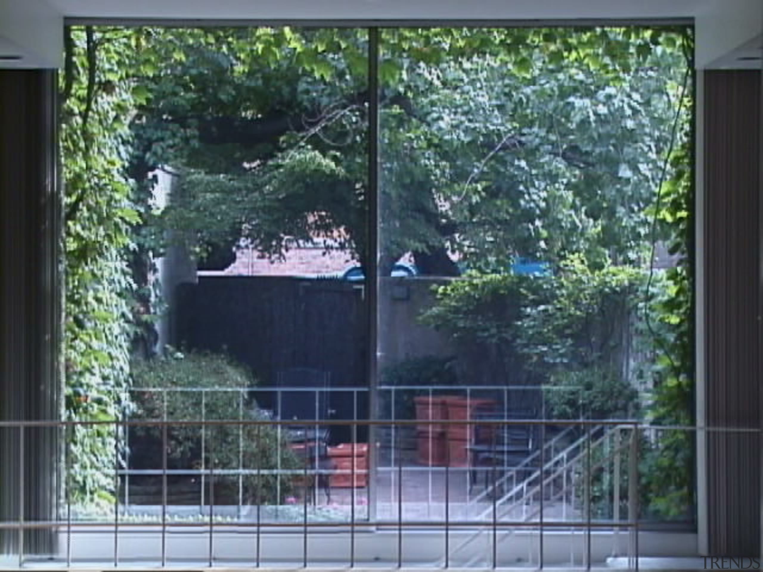 View of the rear side of the house architecture, door, facade, fence, gate, glass, home, house, property, real estate, residential area, sash window, shade, tree, wall, window, window screen, window treatment, yard, black