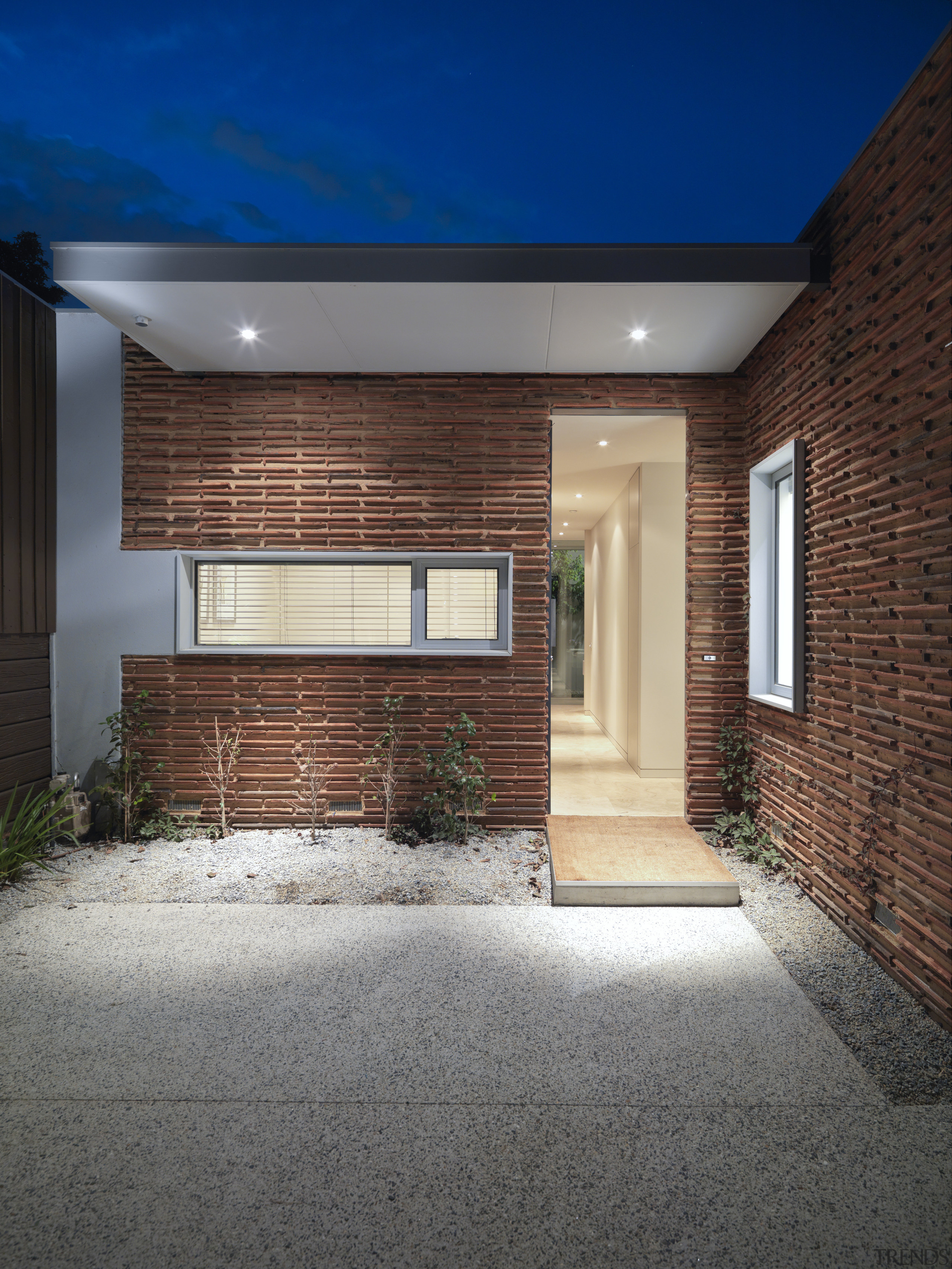 Exterior view of the front entrance featuring terracotta architecture, brick, daylighting, estate, facade, home, house, property, real estate, residential area, siding, wall, window, gray